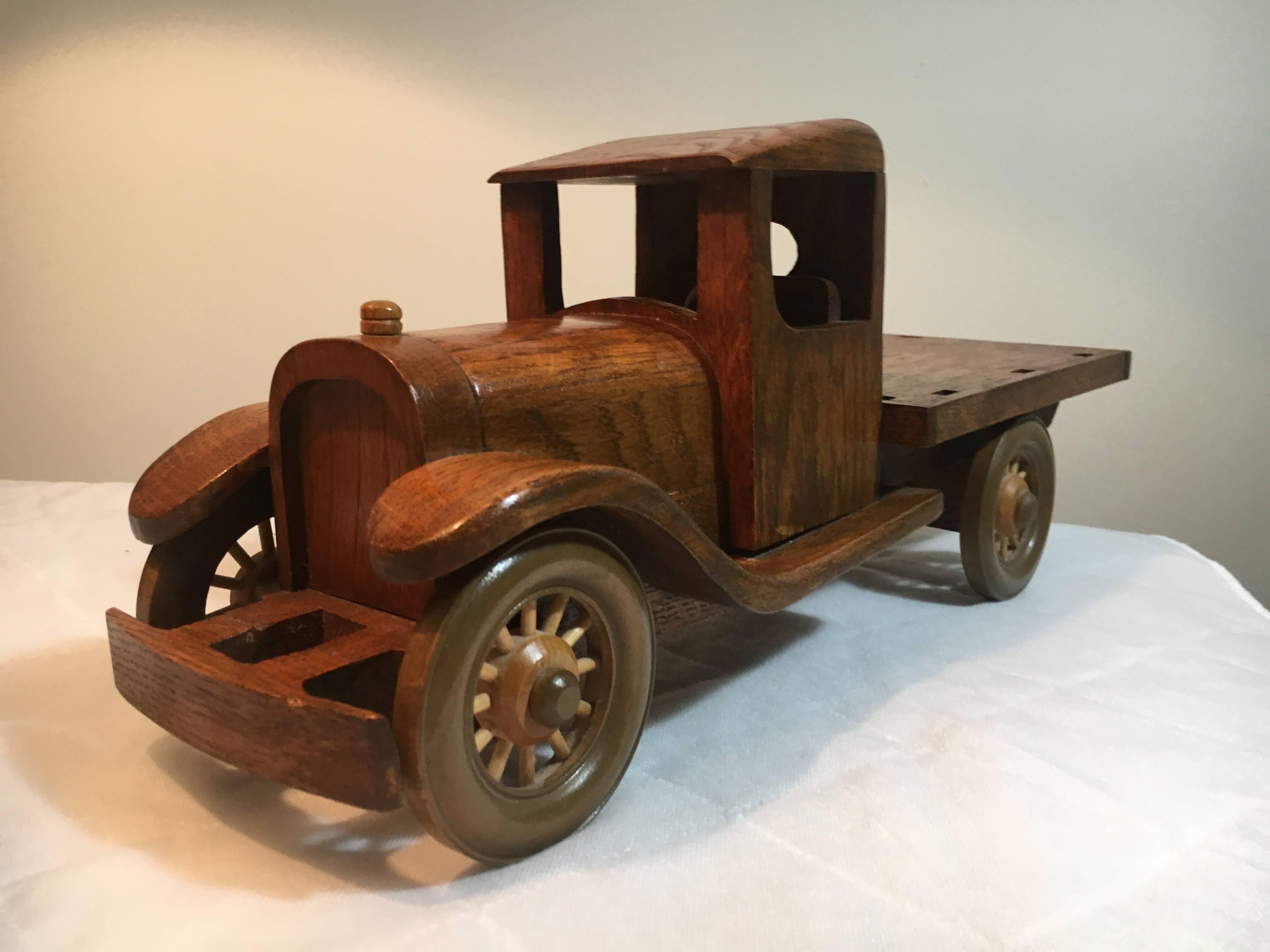 Wooden Folk Art toy truck with removable stakes. Beautifully made wooden stake bed truck with removable stakes - wheels turn and work, signed by the Artist, Ed Bennett - Madison, Indiana.