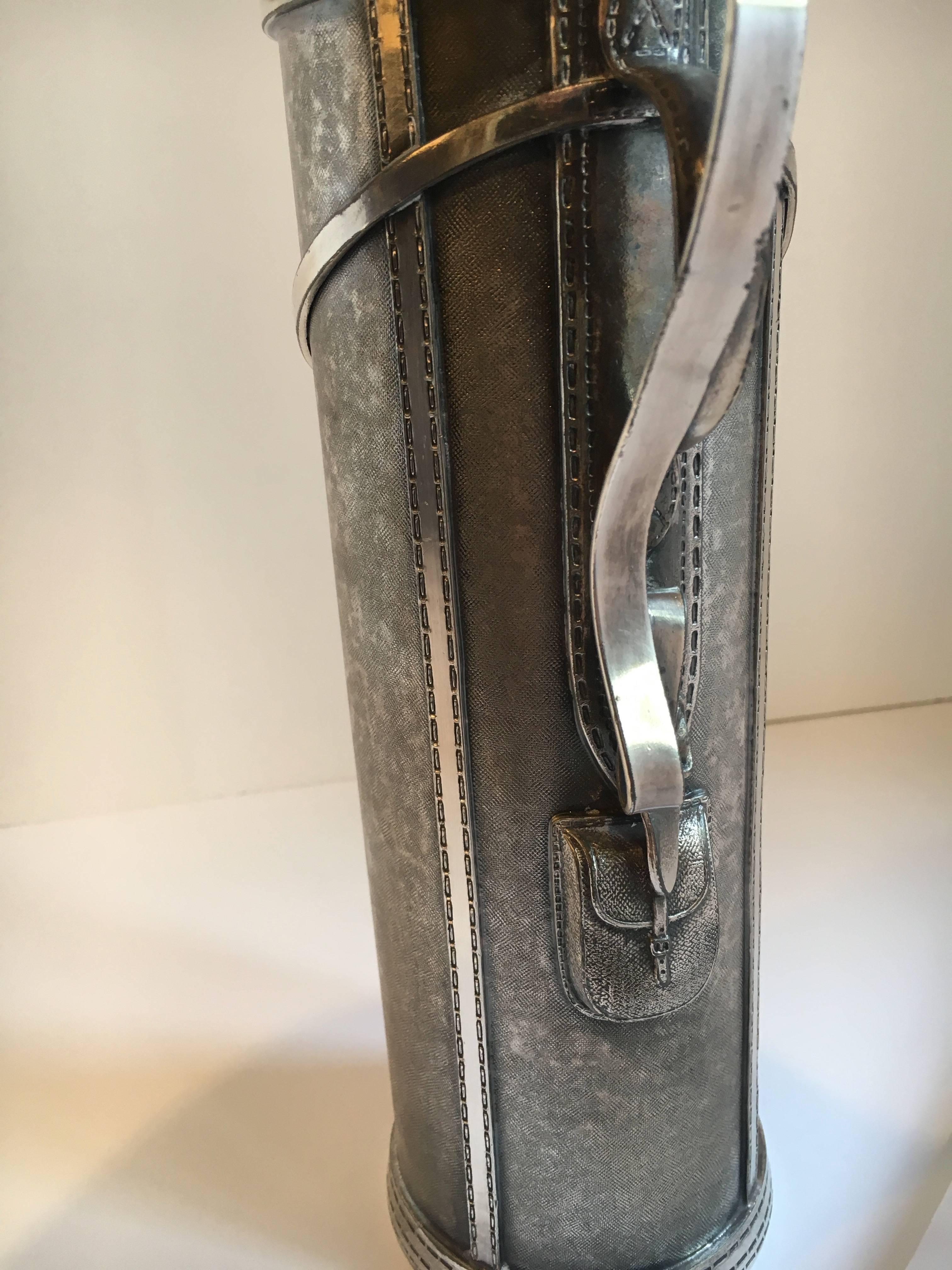 An exact duplicate of a golf bag, detailed down to the stitching, this Shaker, by George J. Berry is the first Art Deco cocktail Shaker made in the image of another object, i.e., the golf bag - an important S. P. Piece, this shaker not only is a