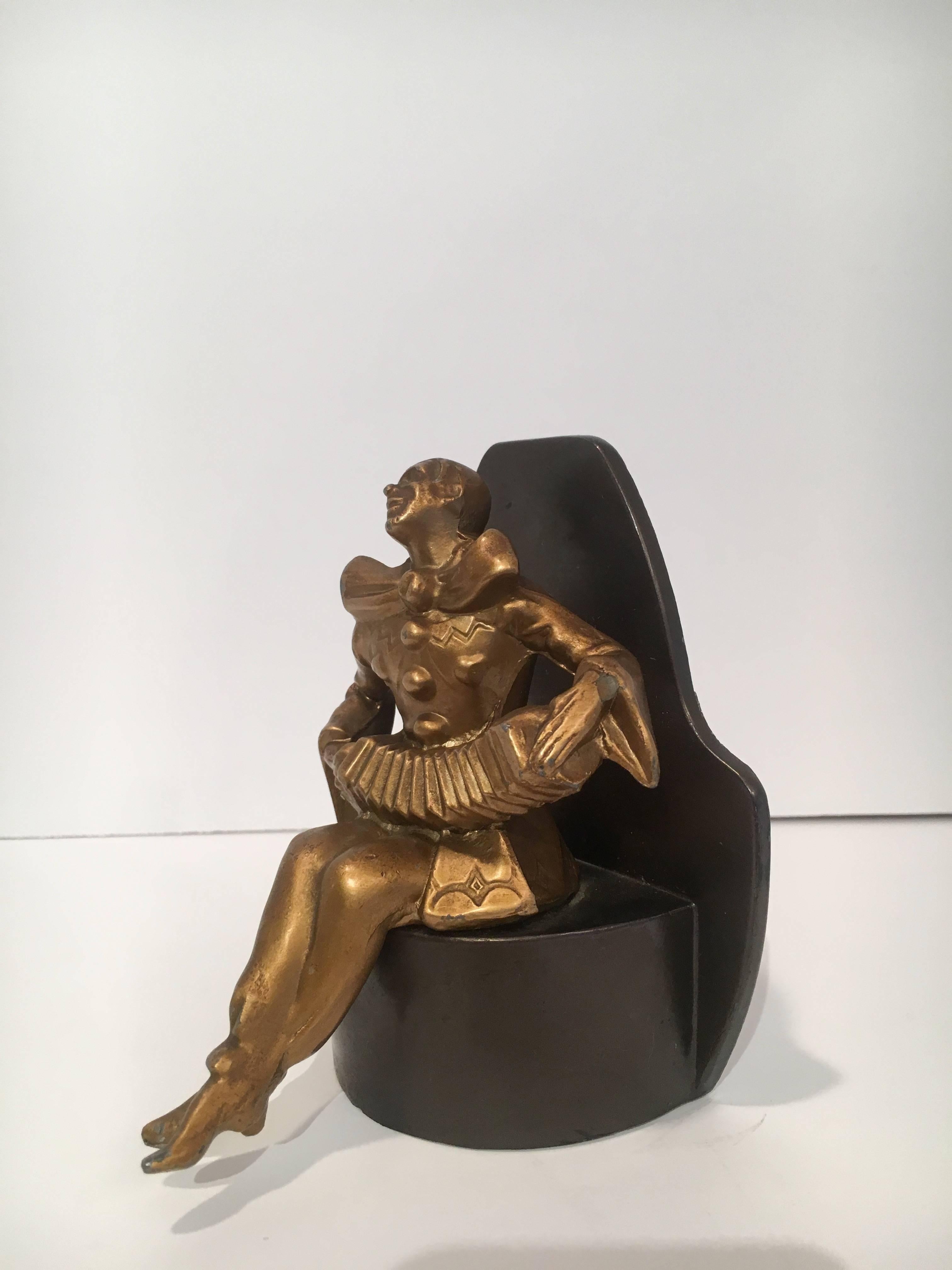 Art Deco gold jester bookend on black base. The jester is glad to watch over your books.