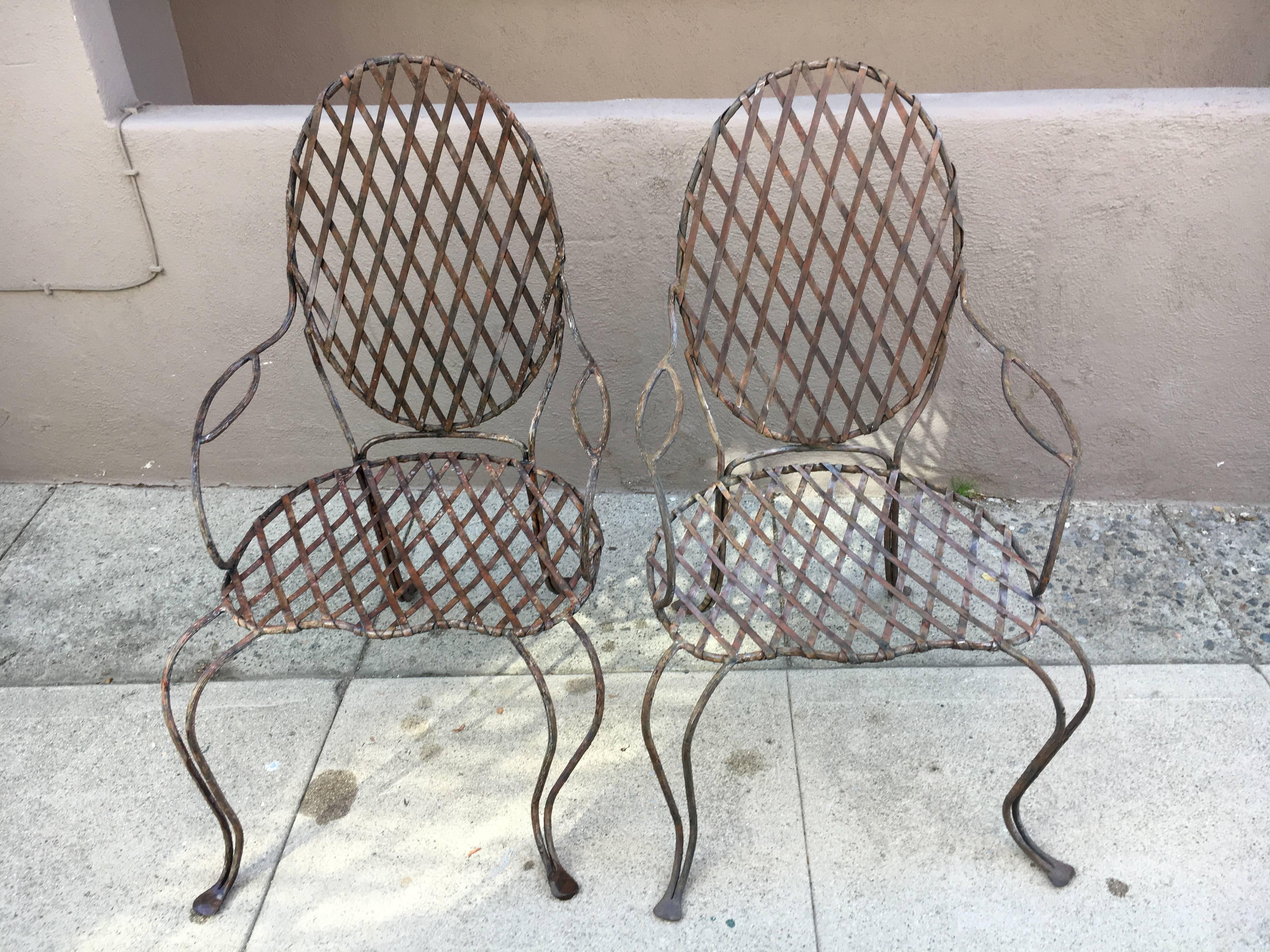 Pair of Twig iron outdoor chairs by Rose Tarlow Melrose House - Rose Tarlow is known as one of the most influential designers in the world, doing homes and custom furniture for the likes of Oprah Winfrey.
The pair of lattice faux bois twig chairs