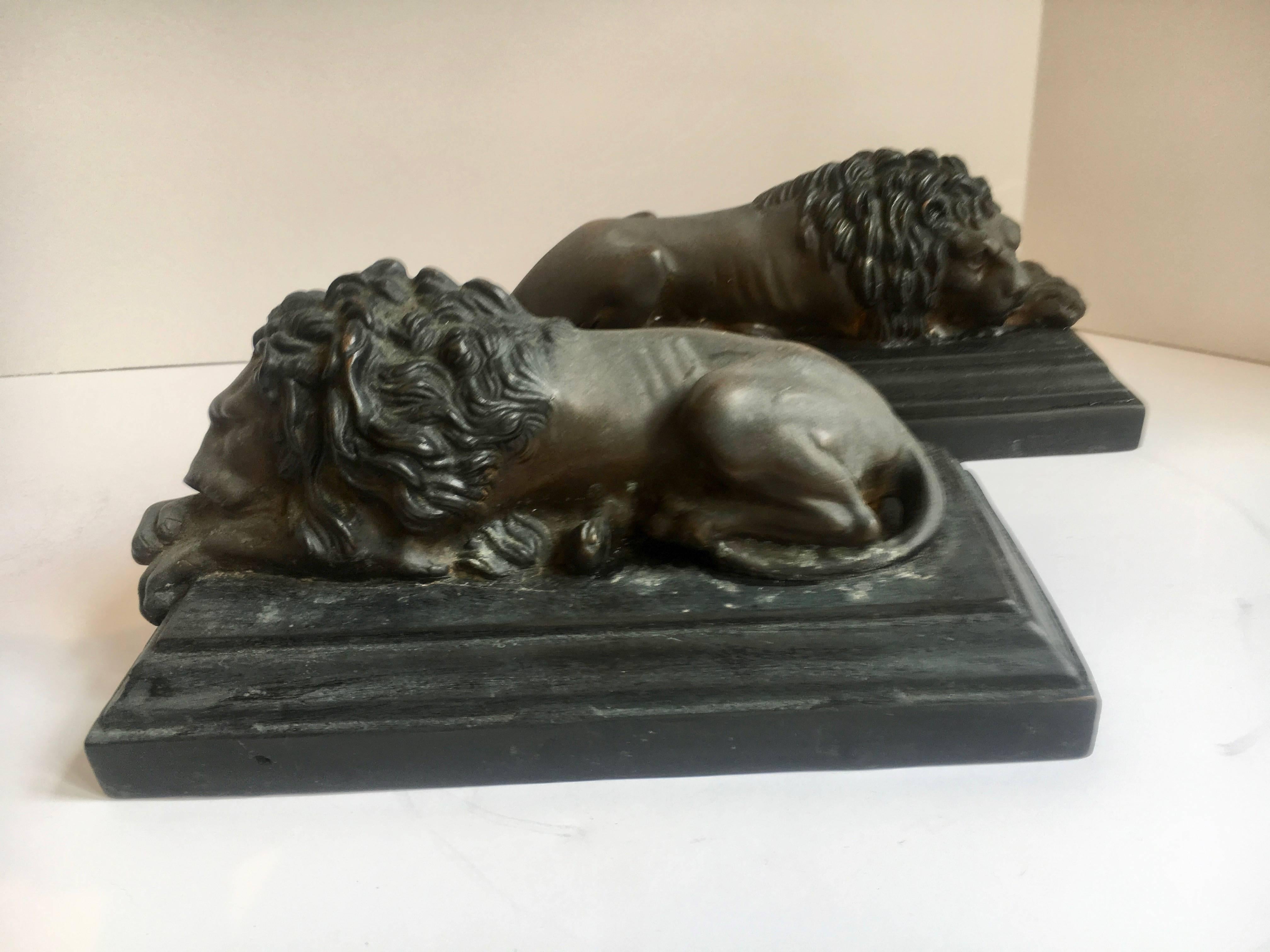Pair of Bronze Recumbent Lion Sculpture Bookends- The pair, on a bronze base with a wooden bottom insert, can easily relax on any shelf or perhaps hold a few books? - their low design may not make them the best bookend, but you are the librarian.