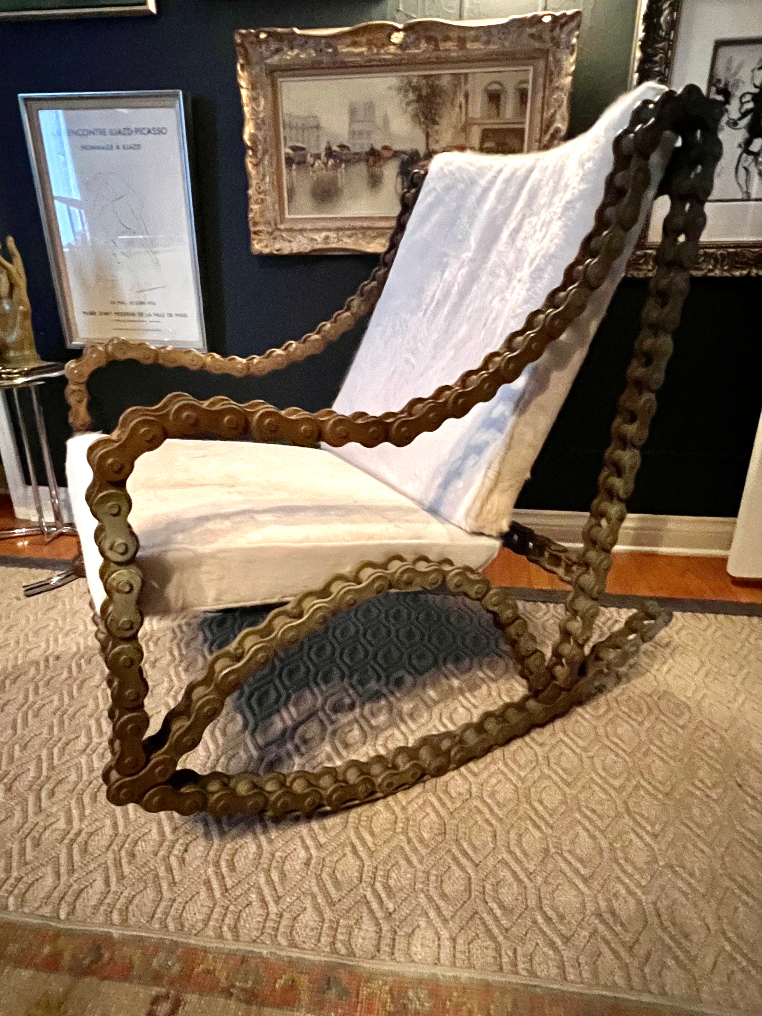 A Art piece that is functional - the piece is comprised of Industrial Chain and welded to become a rocking chair - the piece is definitely a statement and should be considered a functional and sculptural art piece - the cushions are new and custom