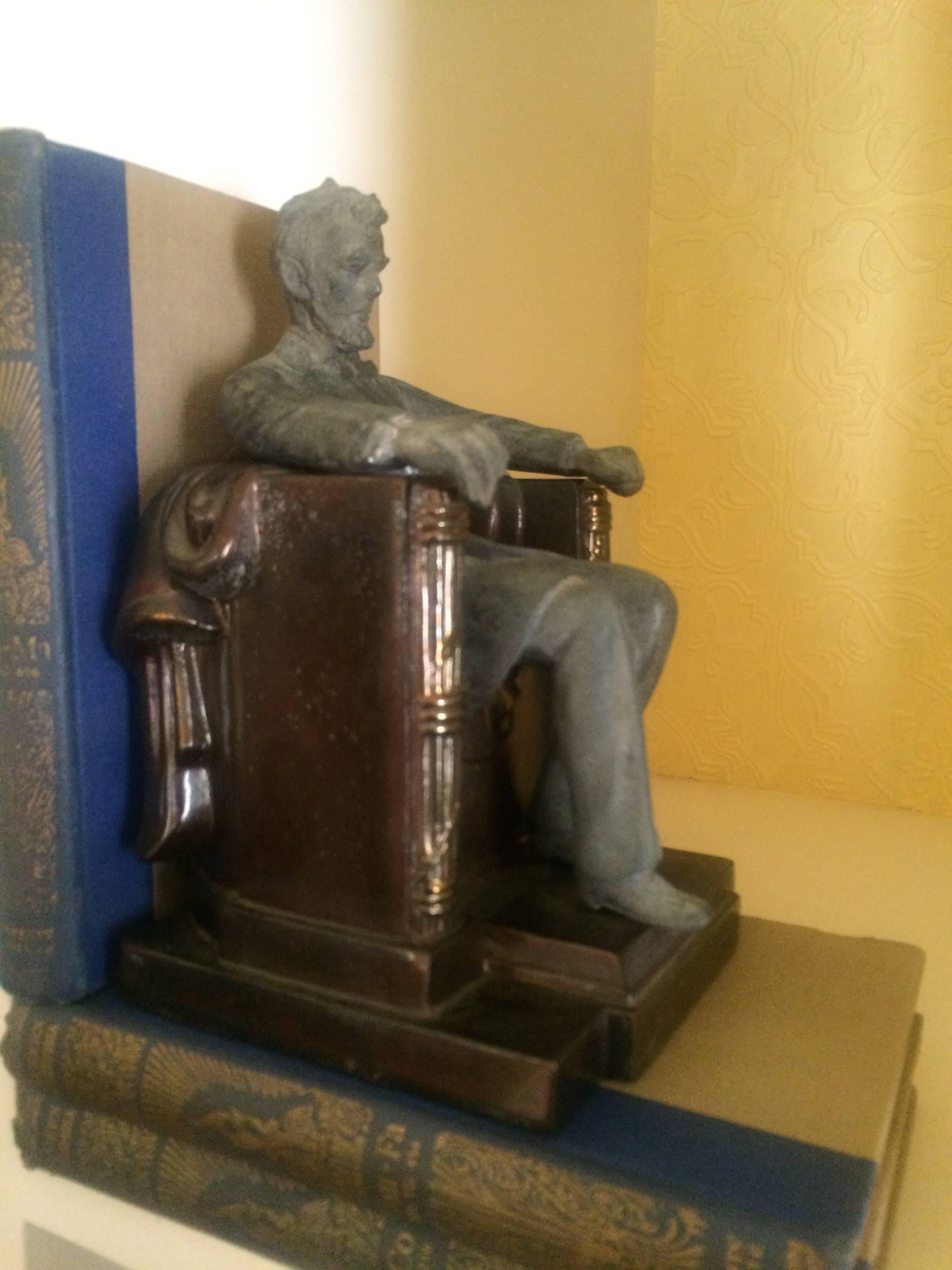 This very special Lincoln monument bookend is one bookend in two pieces. Lincoln actually can come out of the seat and keep you company elsewhere!

Metallic copper finish to Lincoln's stern and matte metal is a great book end in any case of