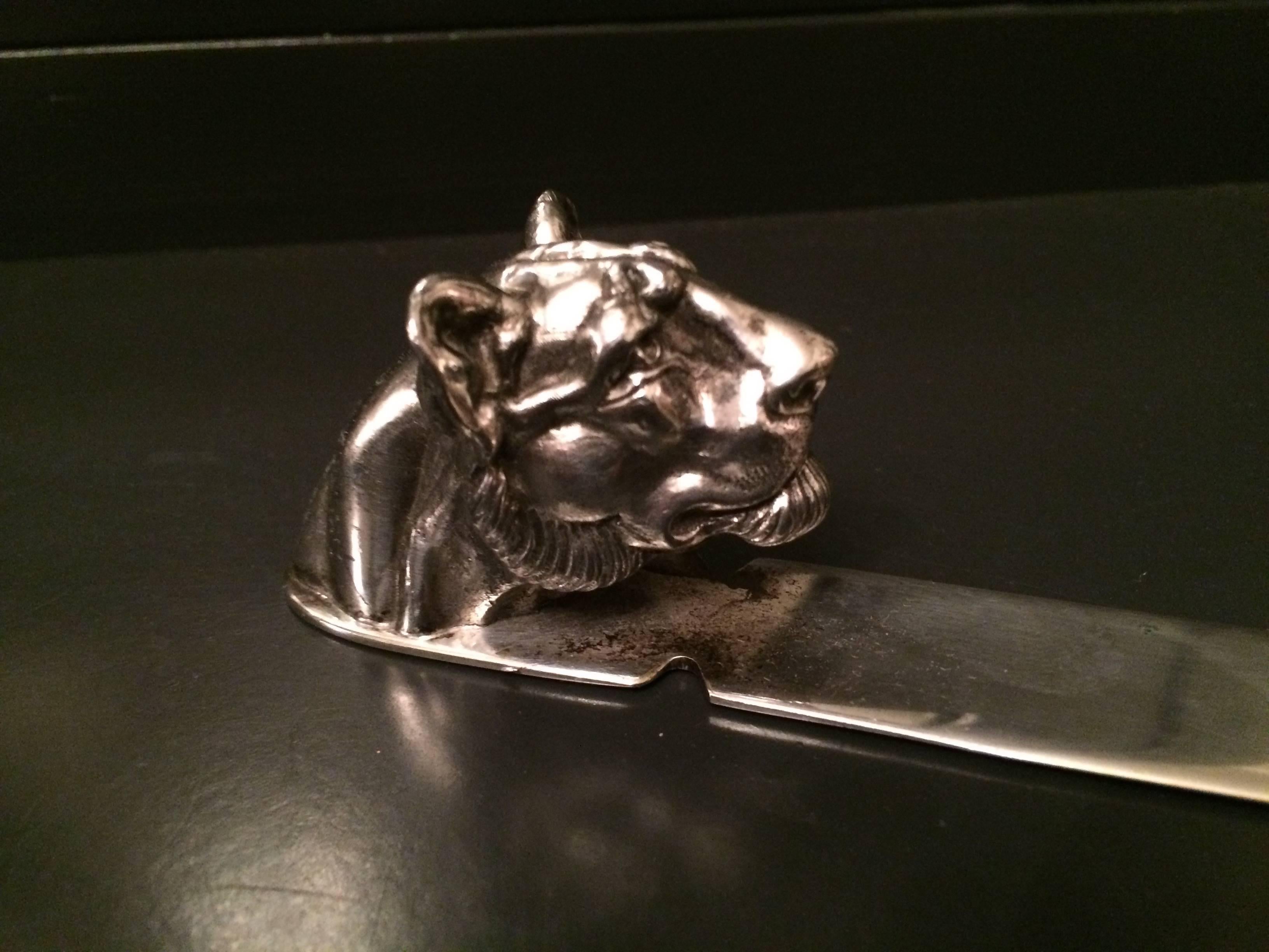 This is a stunning and nicely detailed lions head letter opener by Reed & Barton. The piece is large and carries a nice weight, perfectly used as a letter opener or decorative object / paper weight in any office!