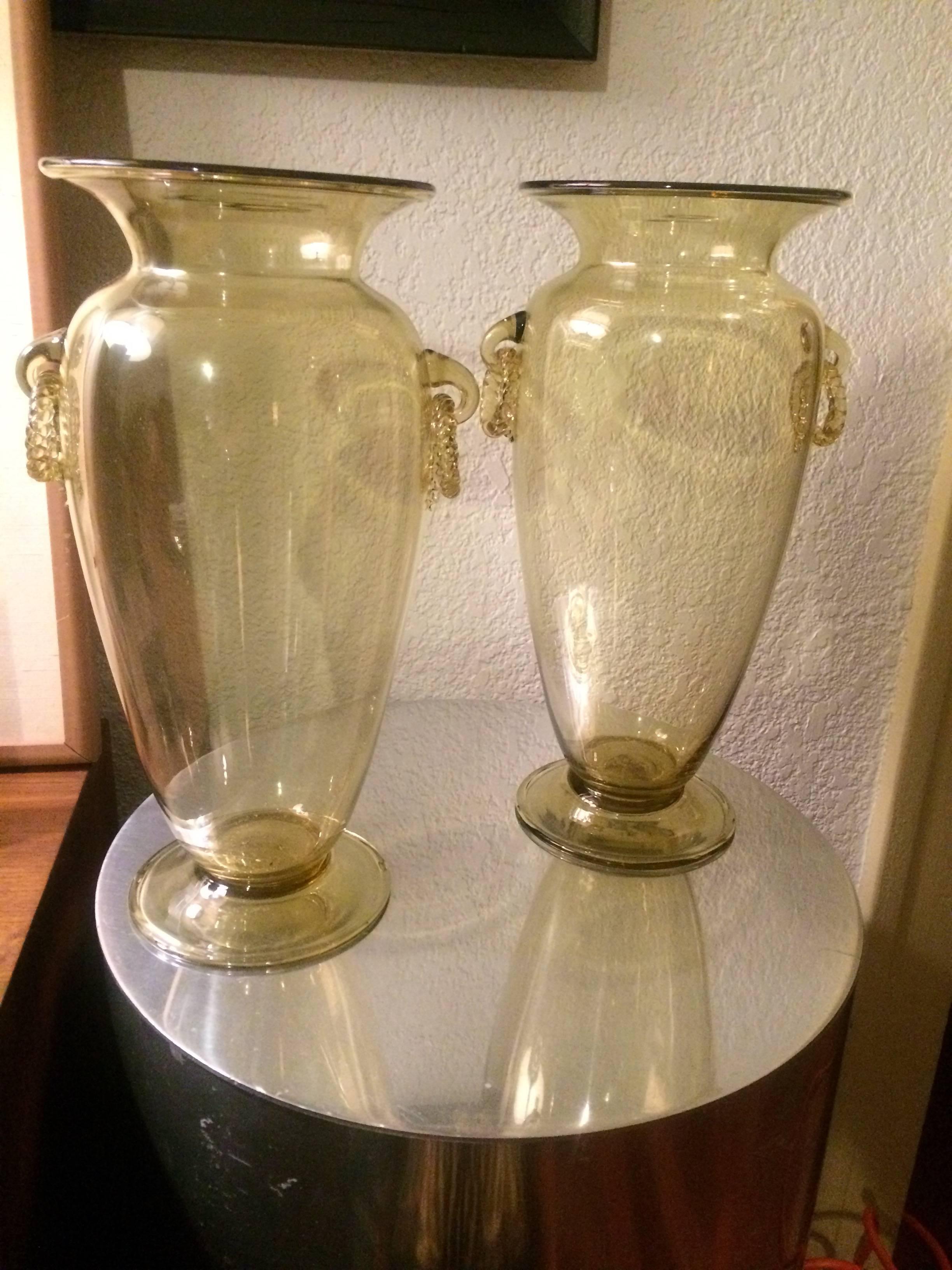 This stunning pair of handblown Venetian glass vases are unique in style, quality and color. The Champagne tinted glass with independently blown and rings, are not stationary, but dangle, are exquisitely designed and perfect for the buffet, formal