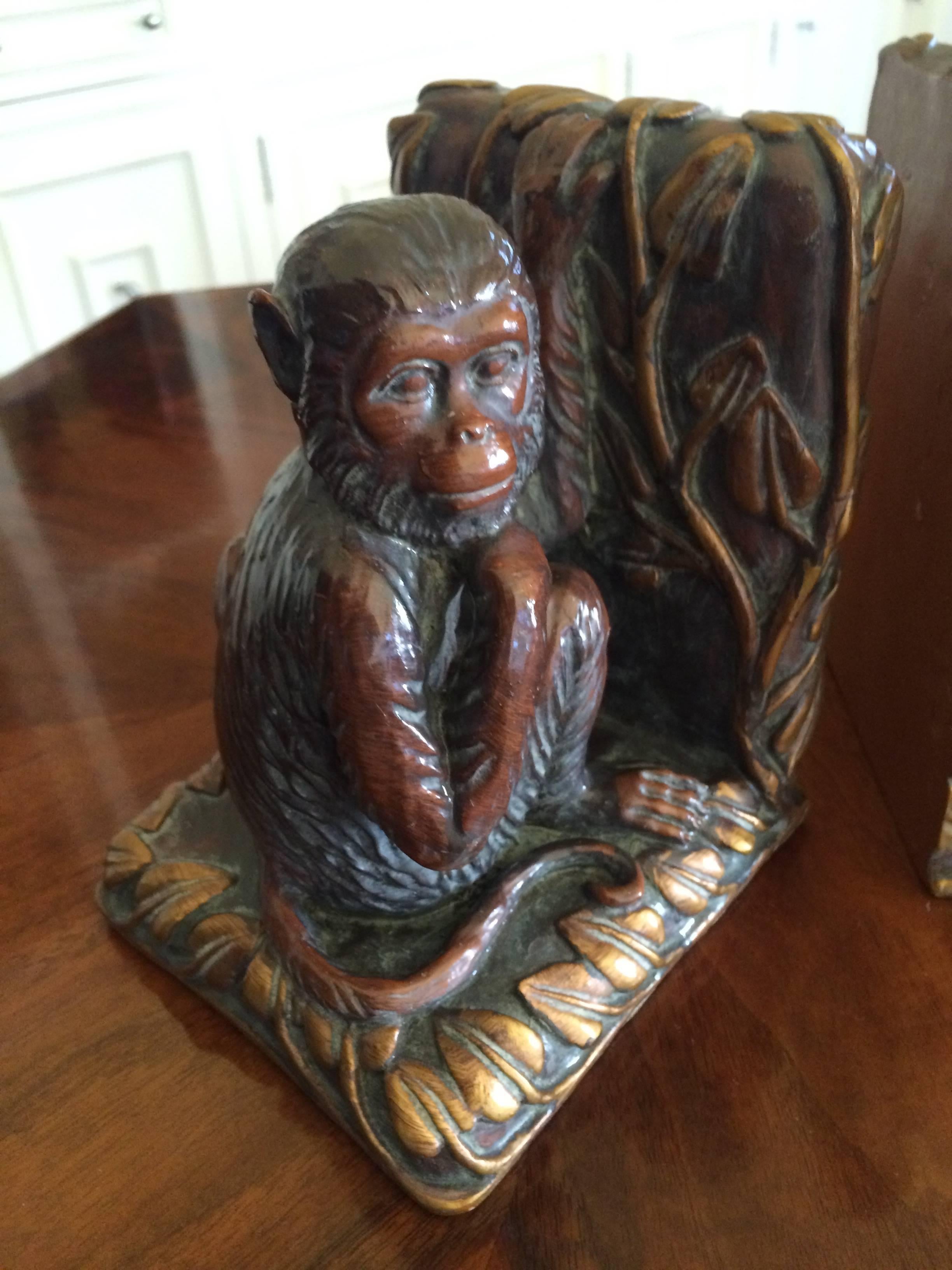 Phenomenal pair of book ends with a Monkeys.  We are reminded of the sophisticated and whimsical, Tony Duquette, as the pair are beautifully paired - one Monkey peering across at his mate and baby Monkey.

The material appears to be plaster with
