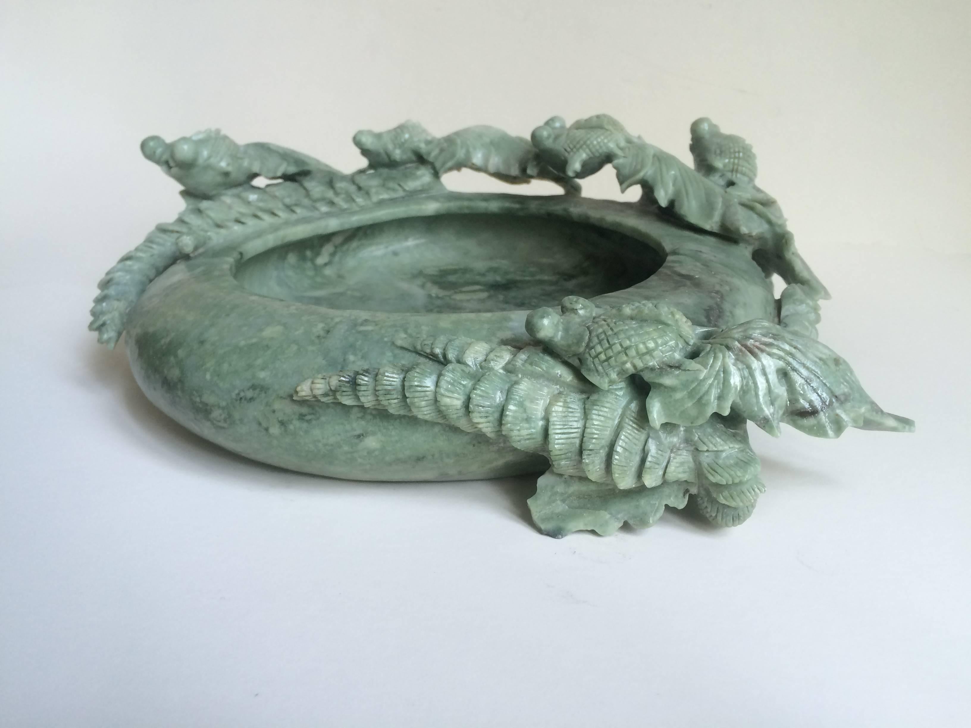 Immaculately carved shallow Jade bowl. Intricately carved fish surround the bowl, carving continues to bottom of piece with great detail.
    