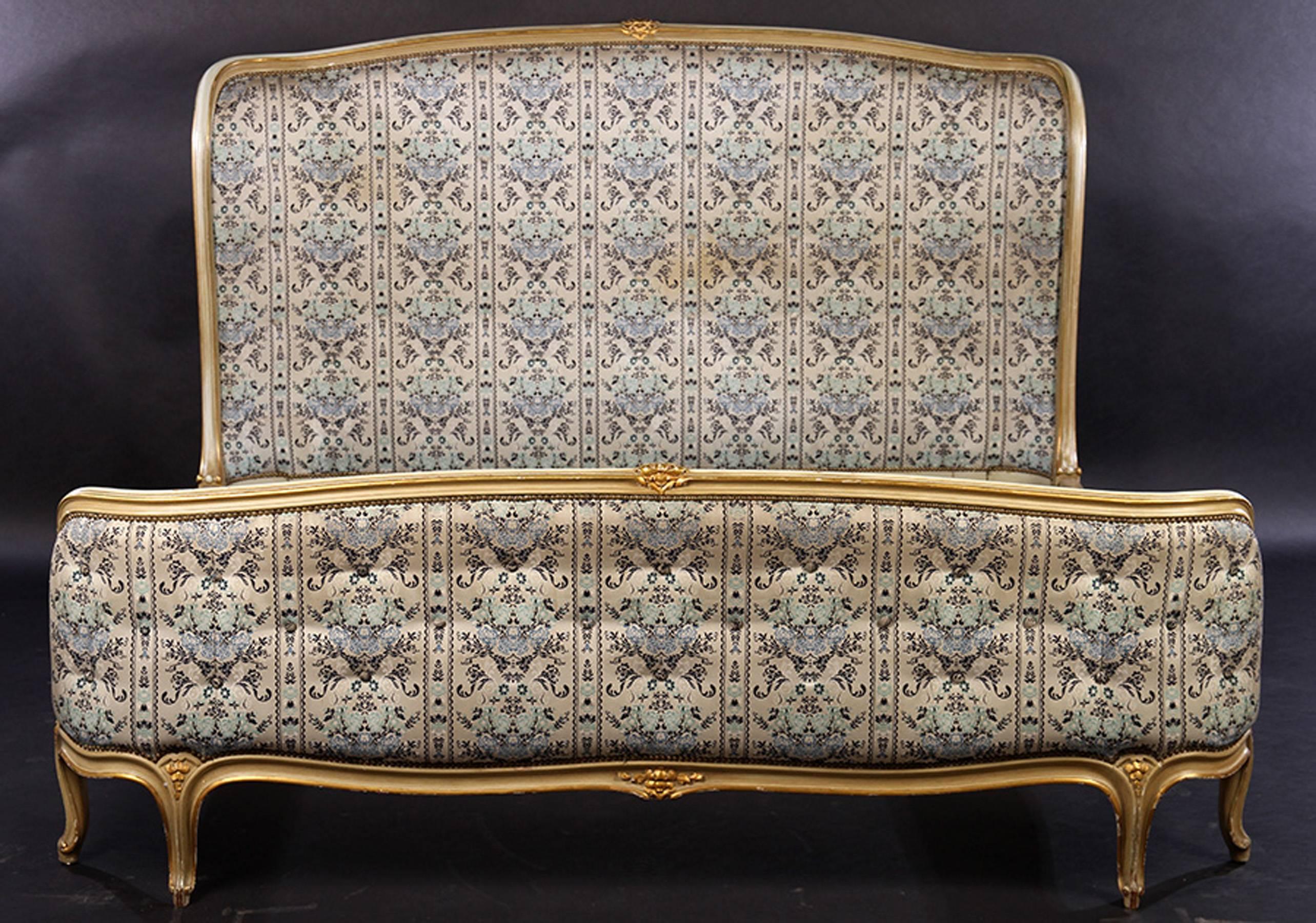 A 20th Century French Louis XV upholstered bed with original tufted upholstered head and foot boards. Very good painted carving with giltwood accents. Original Finish.

Mattress dimensions: 67.5'' W x 75.5'' L,  7'' Height from floor to box spring.