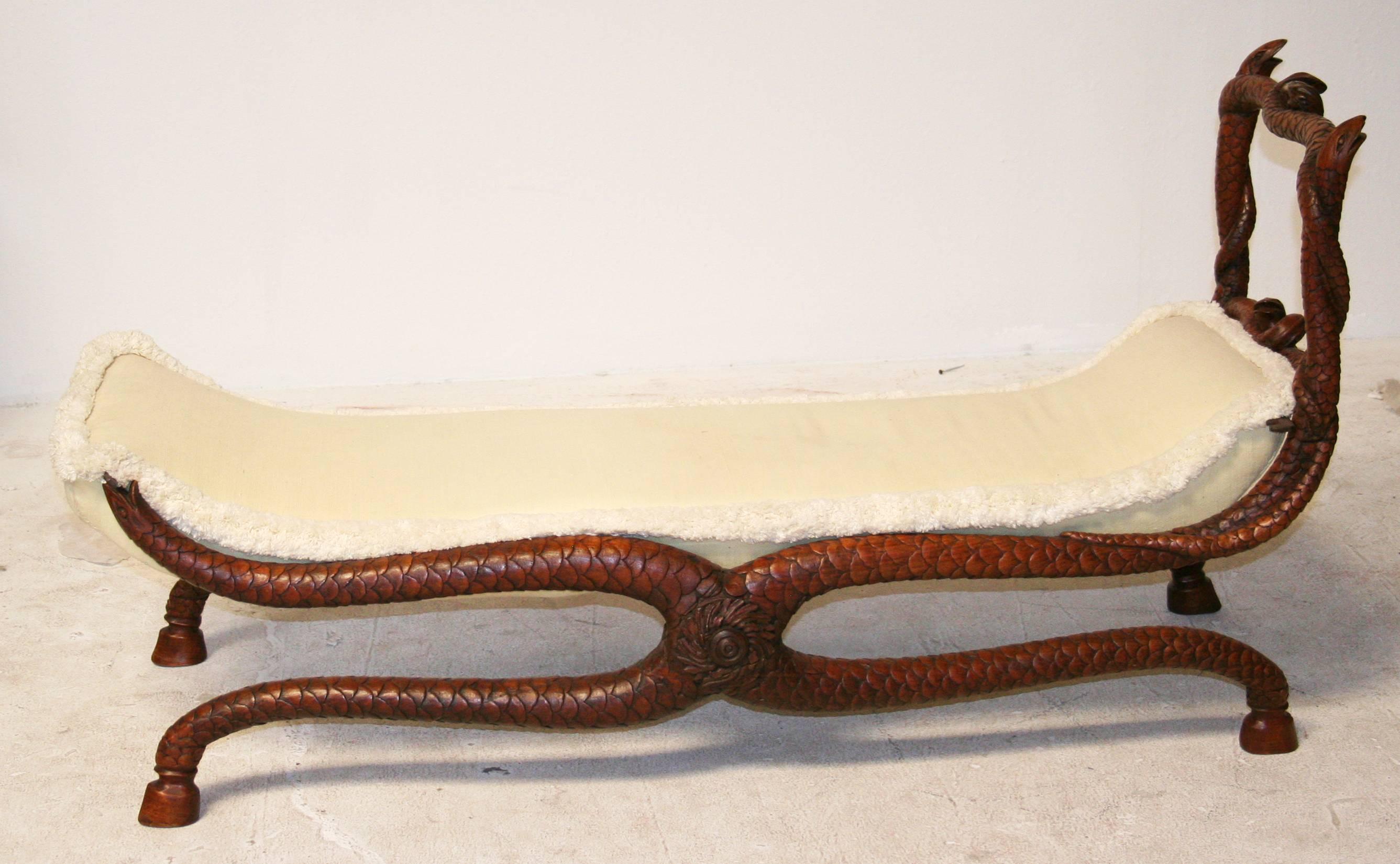 A whimsical carved walnut daybed from the estate of Merv Griffin, of entwined serpents supporting an upholstered bench. Small scale is ideal child size daybed.