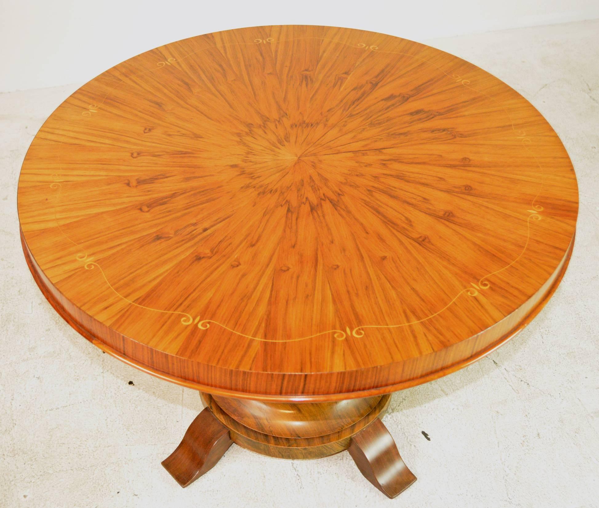 A French Art Deco occasional table with ribbon inlay on a radial veneer top in the style of Jules Leleu.