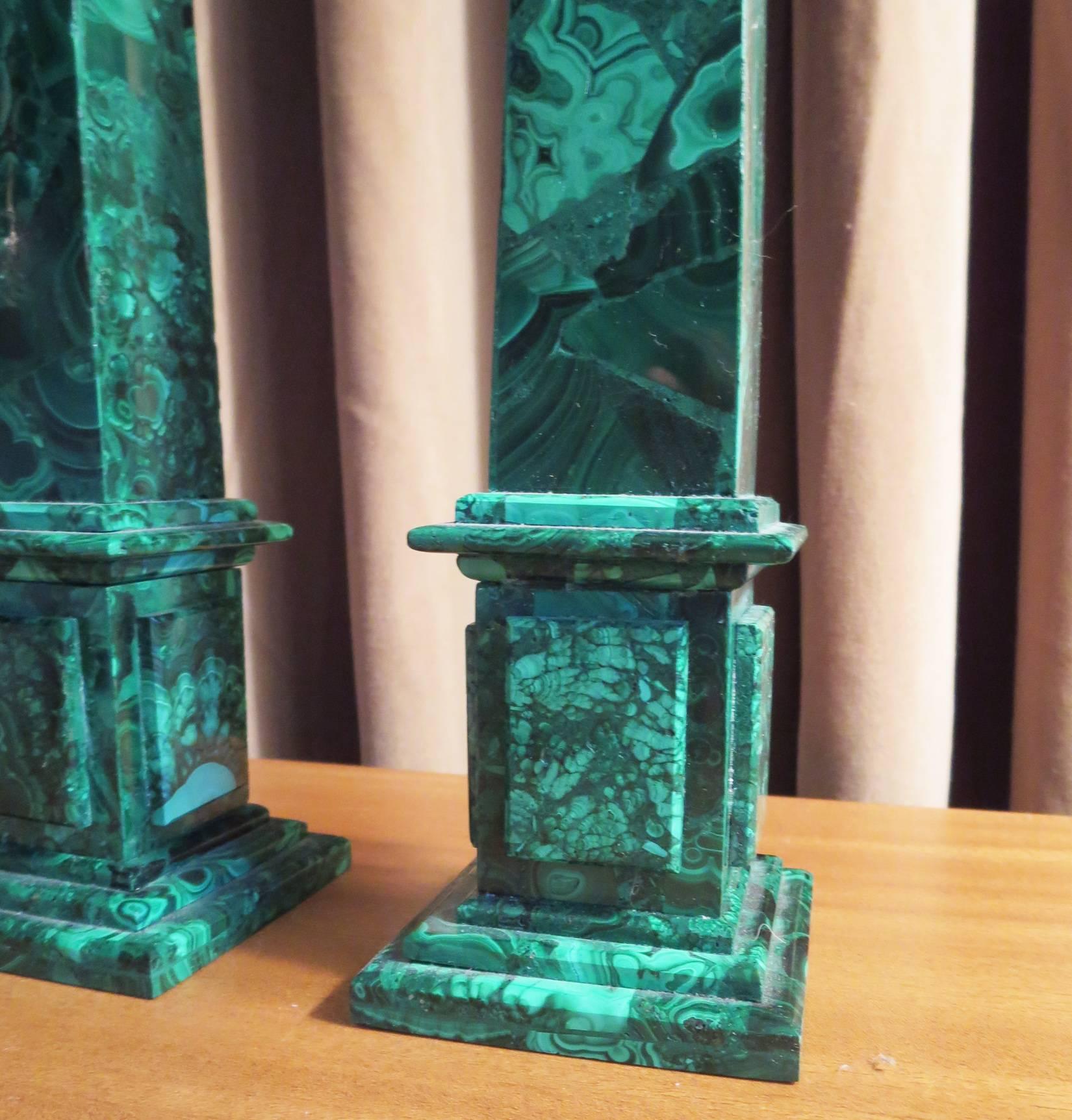 A pair of Russian neoclassical style obelisks of malachite. Square, tapered shafts on a raised panel stepped base. Great color to malachite. One obelisk has a slight 'lean' to the upper shaft.
