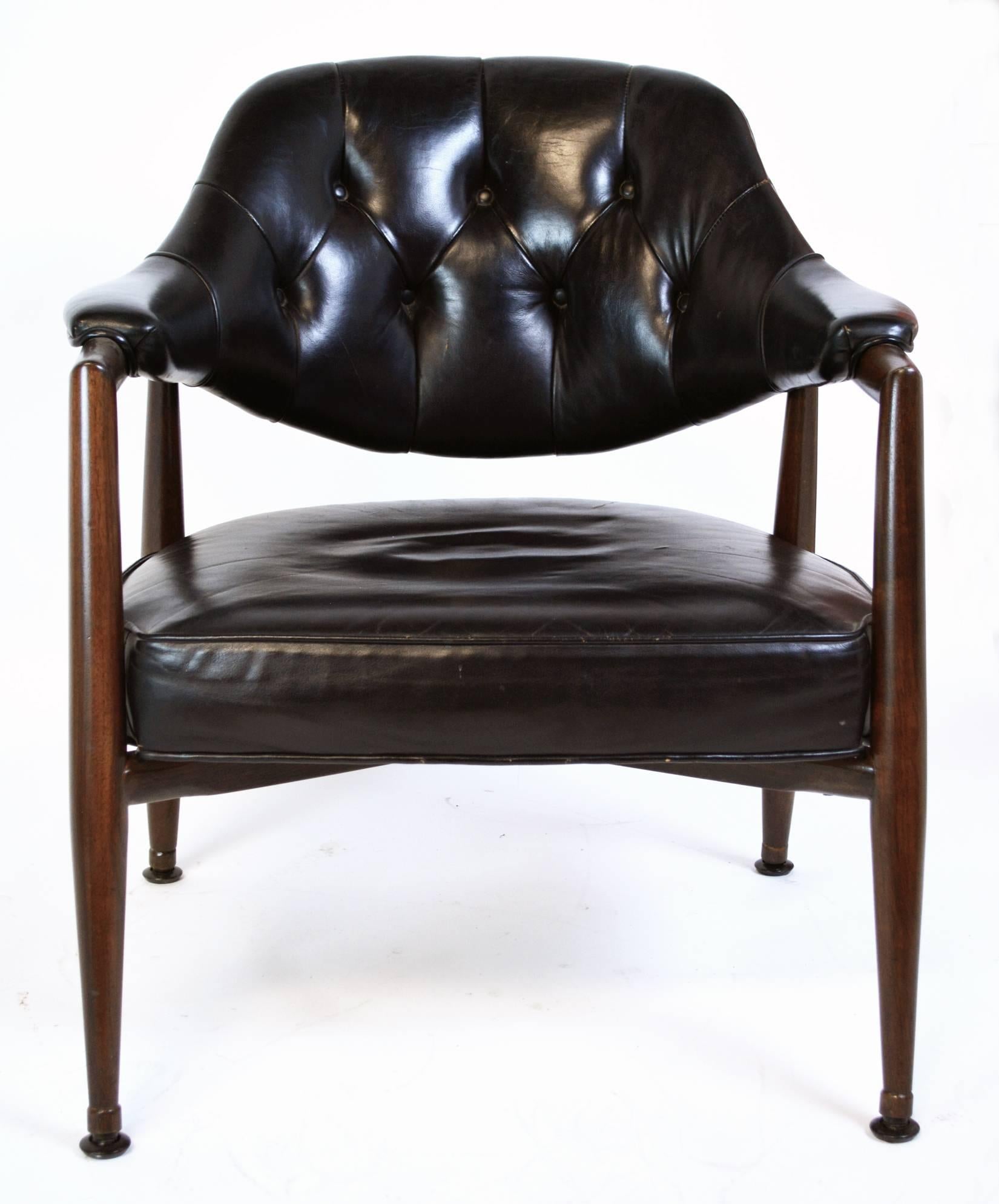 A pair of walnut frame armchairs by Maurice Bailey for Monteverdi-Young, with original tufted leatherette upholstery. Frames have been refinished.