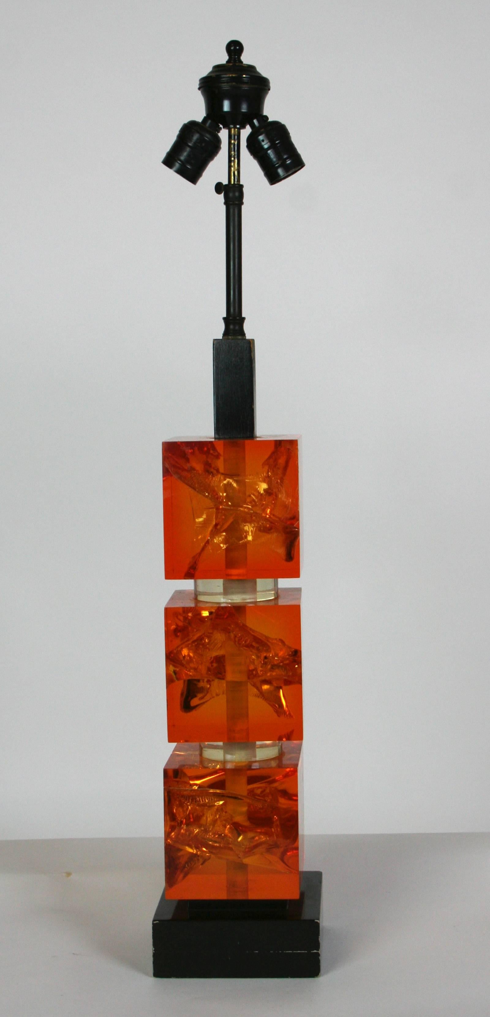 Three amber fractal resin blocks separated by clear resin discs on a black plinth. Shade for display only. 