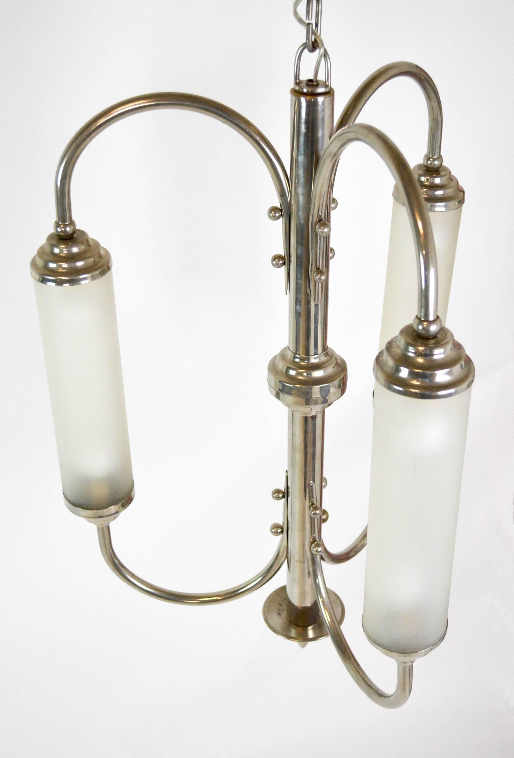 A sculptural chandelier consisting of three arms holding three lit frosted glass tubes. Supremely chic, with a very modern feel. Most likely French, but not documented. Rewired and ready for installation. Height listed does not include chain.
