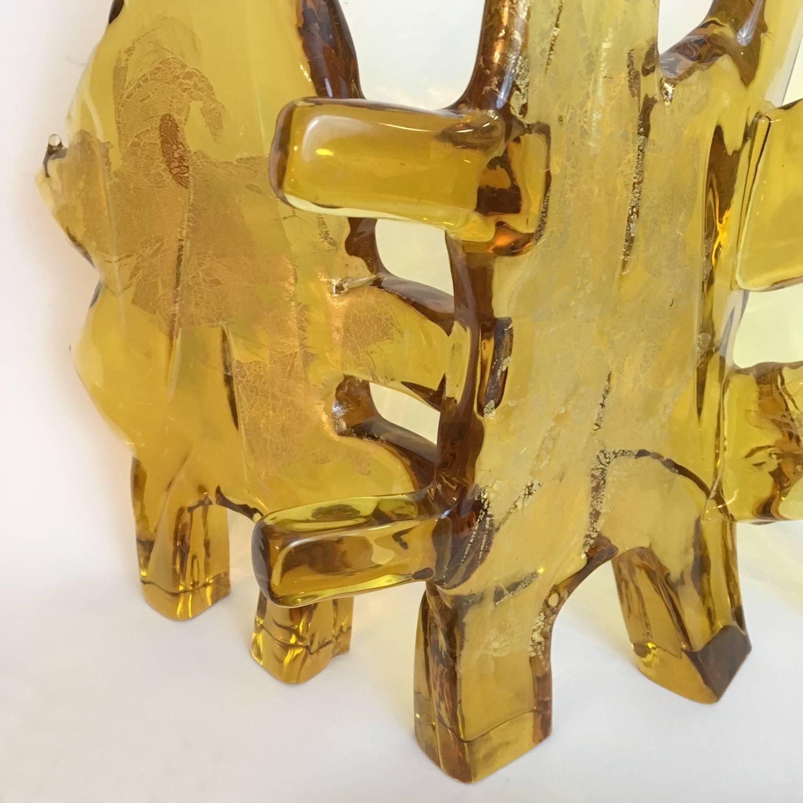 A large abstract sculpture in amber Murano glass with gold leaf inclusions. Three interlocking forms created by Luciano Gaspari for Salviati.