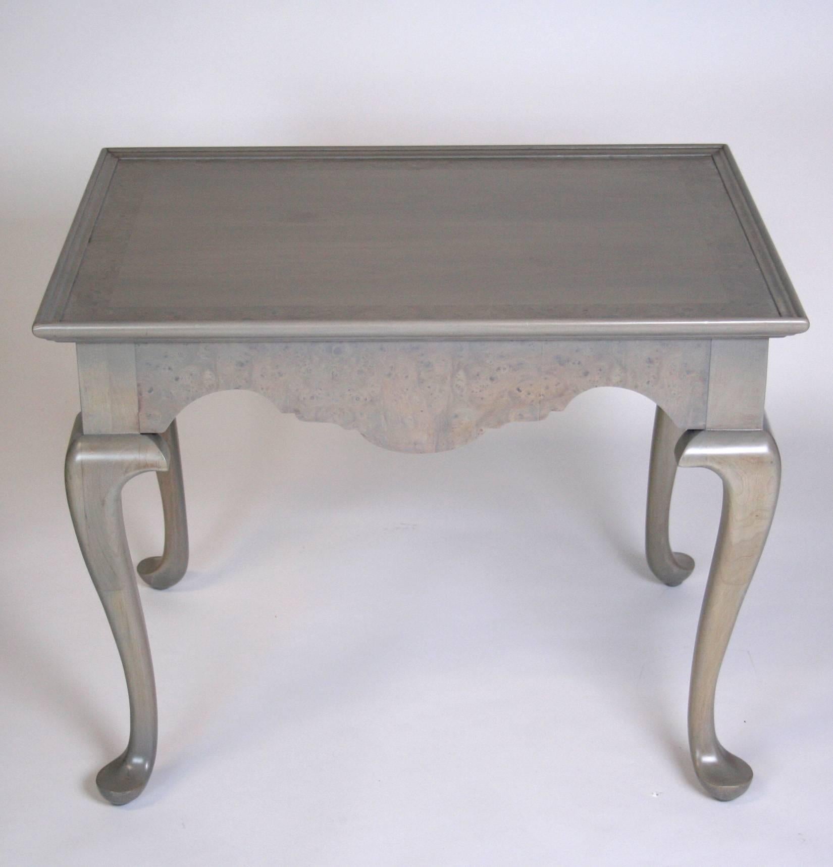 A pair of end tables in the Queen Anne style by Fine Arts Furniture. Scalloped apron has burl veneer, while the try style top has a border of burl. Refinished in a sliver grey stain.