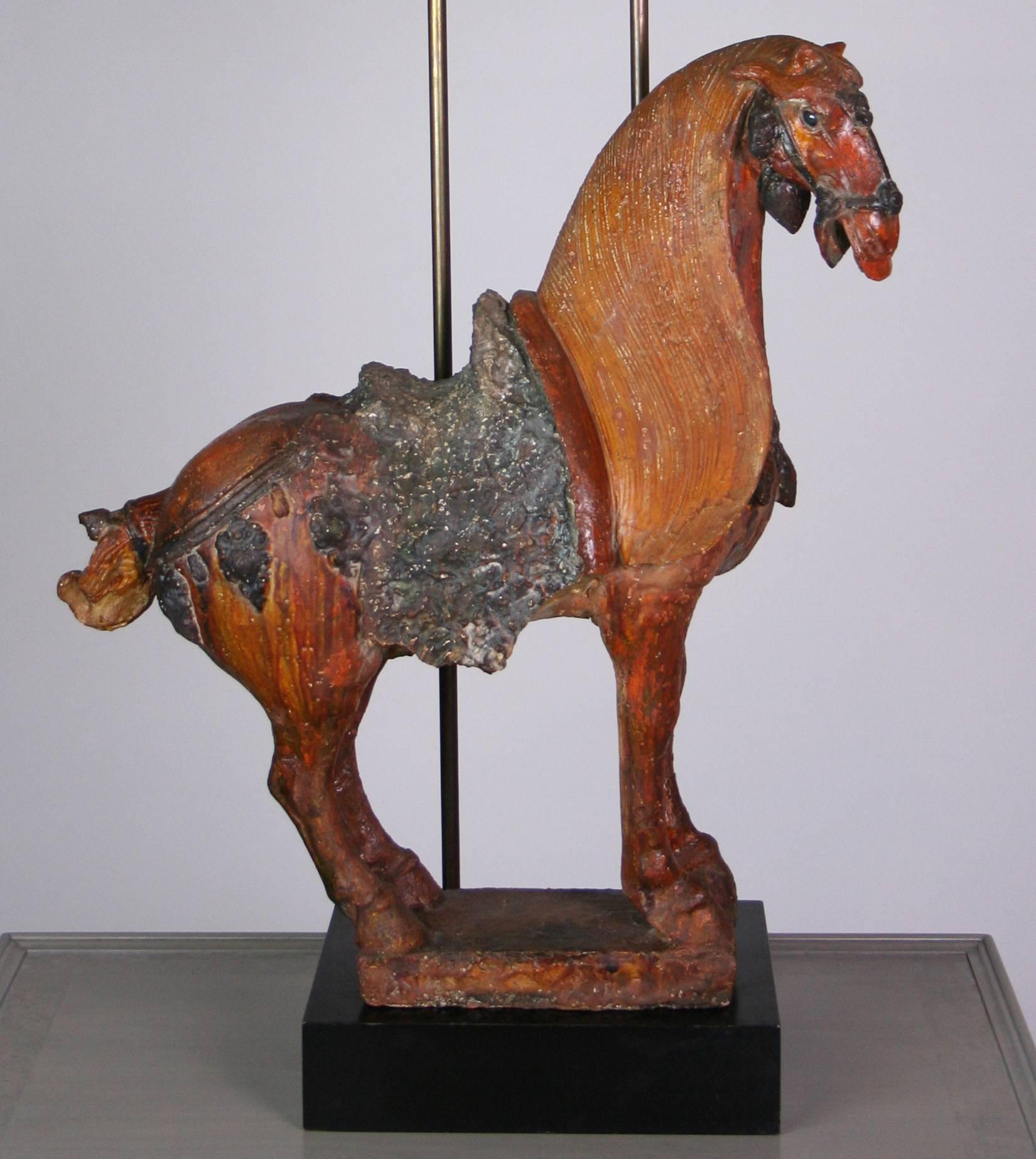 A good Mid-Century Modern painted plaster Tang dynasty style horse, on a black plinth with brass rods supporting a custom box shade. Very Hollywood Regency and Billy Haines style. The horse sculpture is 24