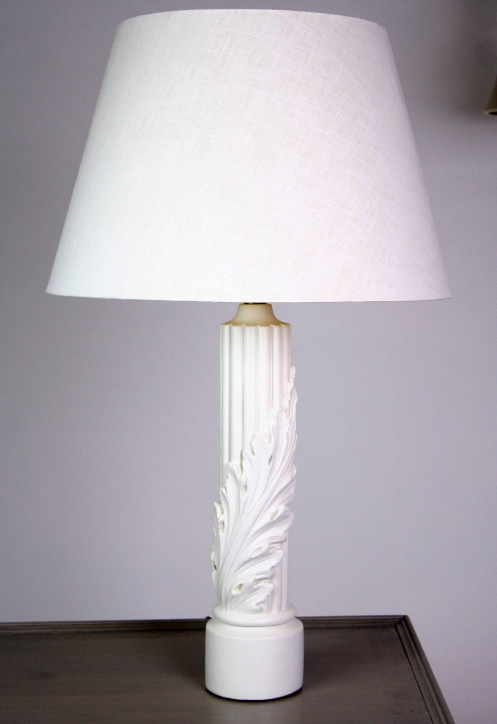 A pair of Art Deco / art moderne / early Mid-Century Modern lamps in painted plaster. A reeded column is wrapped with an acanthus leaf that spirals up from the base. Newly rewired with new pewter sockets. 30 1/2