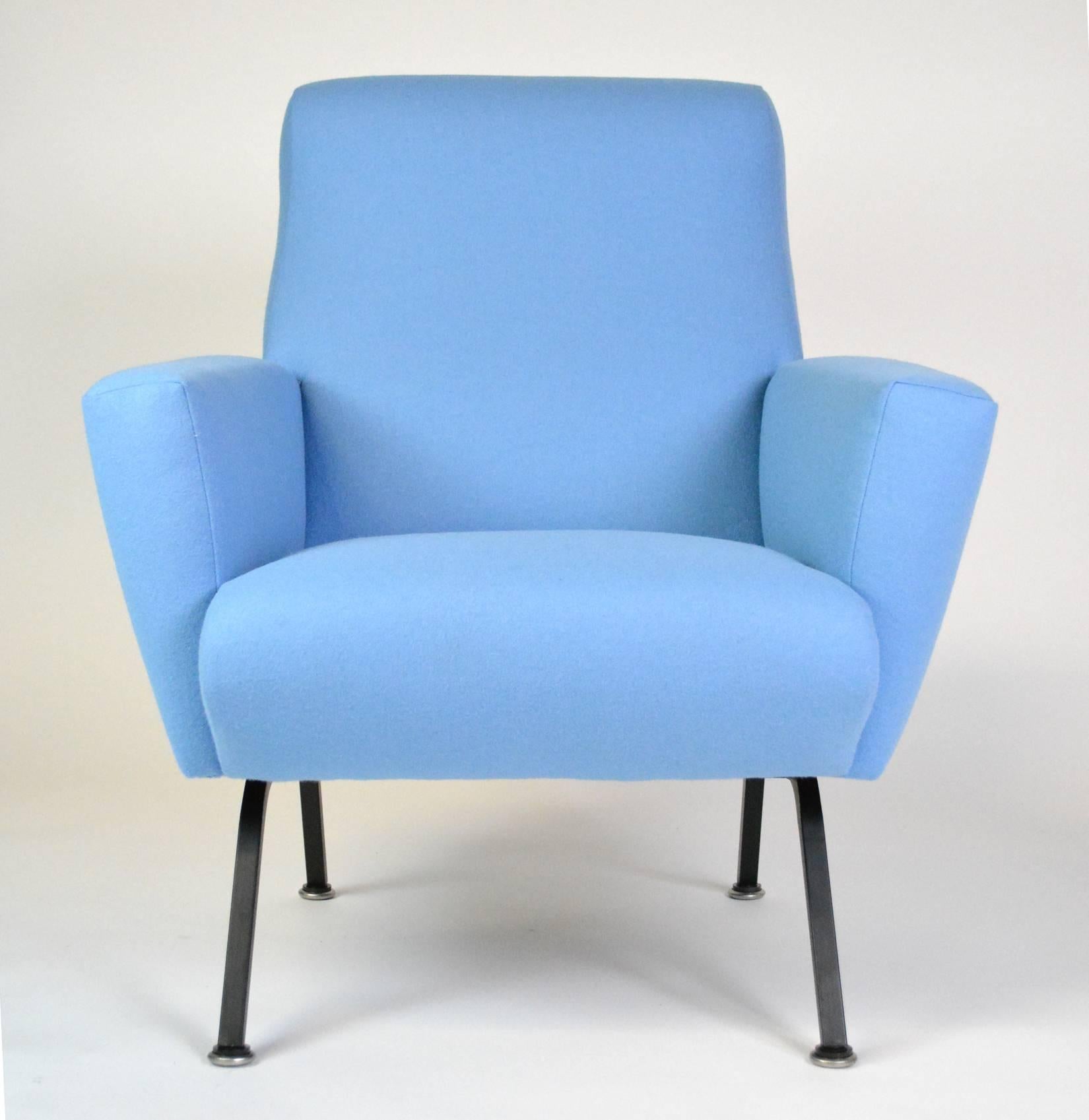 A Mid-Century Modern Italian lounge chair with angular arms and back, on splayed metal legs. the back has a lovely rolled detail. Reupholstered in Maharam Kvadrat felted wool.