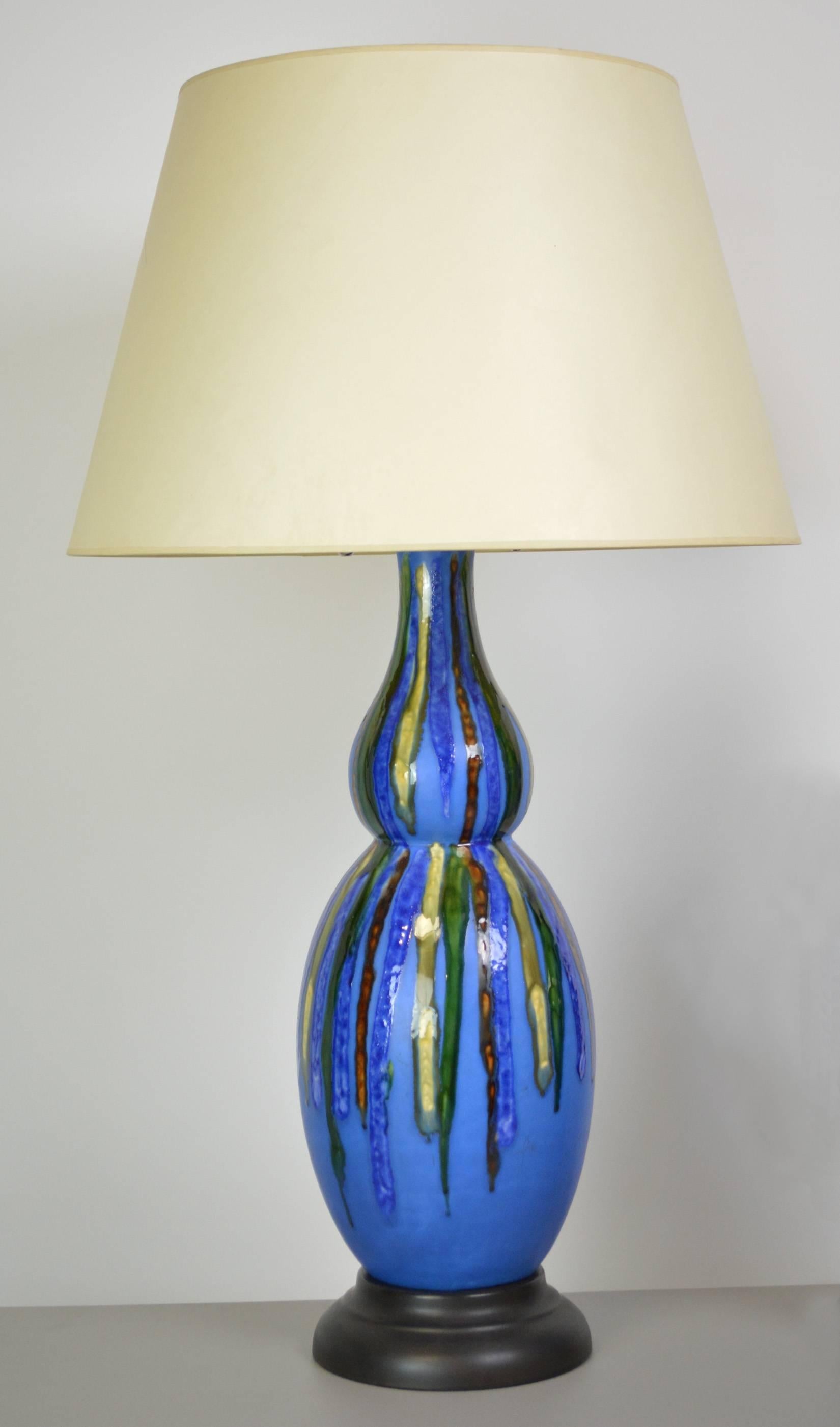 A pair of Mid-Century Modern double gourd lamps with a deep blue matte glaze, with drip glaze decoration in red, yellow and green. Boho chic style perfect for your colorful interior. Newly rewired with double cluster sockets and French braid cloth