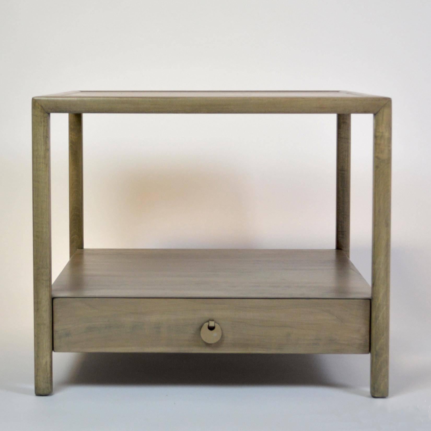 An end table or nightstand by Michael Taylor for Baker Furniture's New World collection. refinished in a pale grey stain.