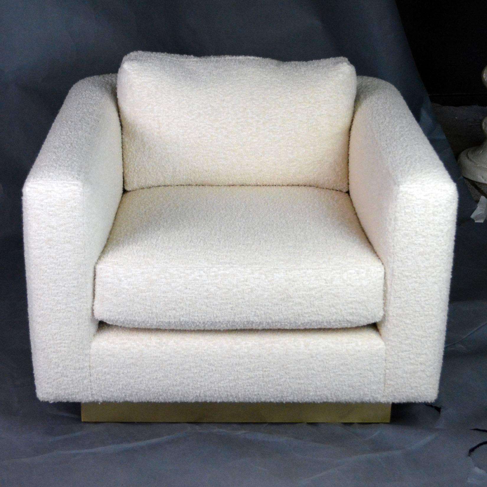 Pair of 1980s club chairs in new ivory wool bouclé. Chic "floating cube" design on a recessed satin brass base with a nice seam detail at the rear. Attributed to Steve Chase but unmarked.
