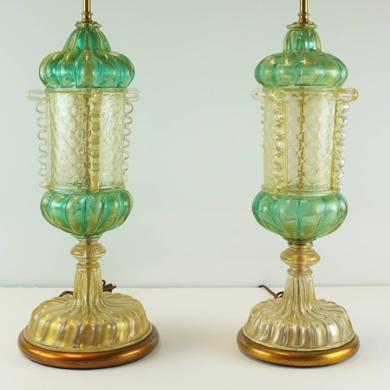 A pair of early 20th century Murano lamps attributed to Barovier. Gold inclusions in both clear of aquamarine glass. Classical canister vase form. Rewired for US use. Height to top of glass is 21