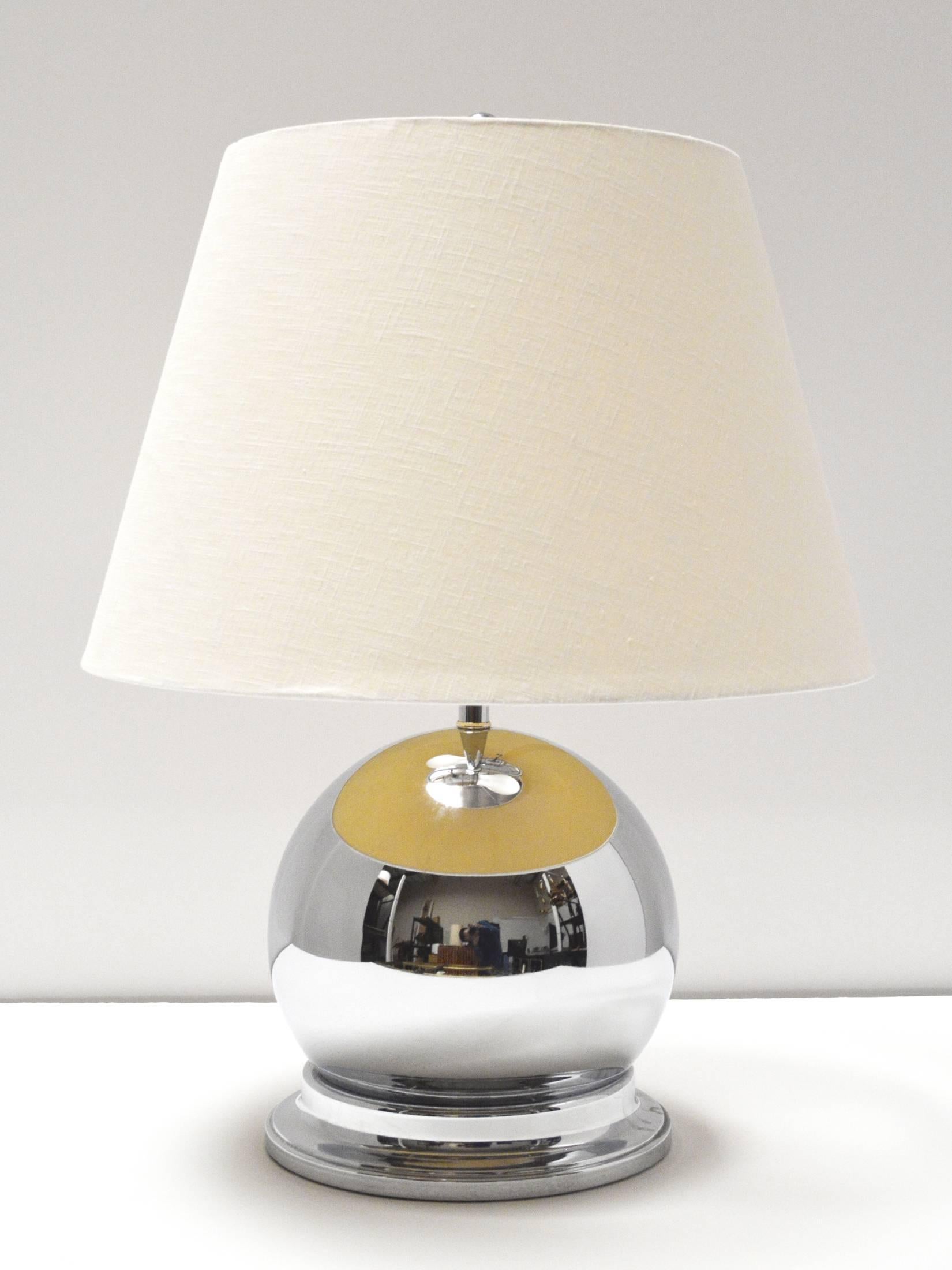 A chic pair of 1980s chrome ball lamps. Double sockets, excellent quality, labeled Norman Perry Lamp Co. Shades for display only.