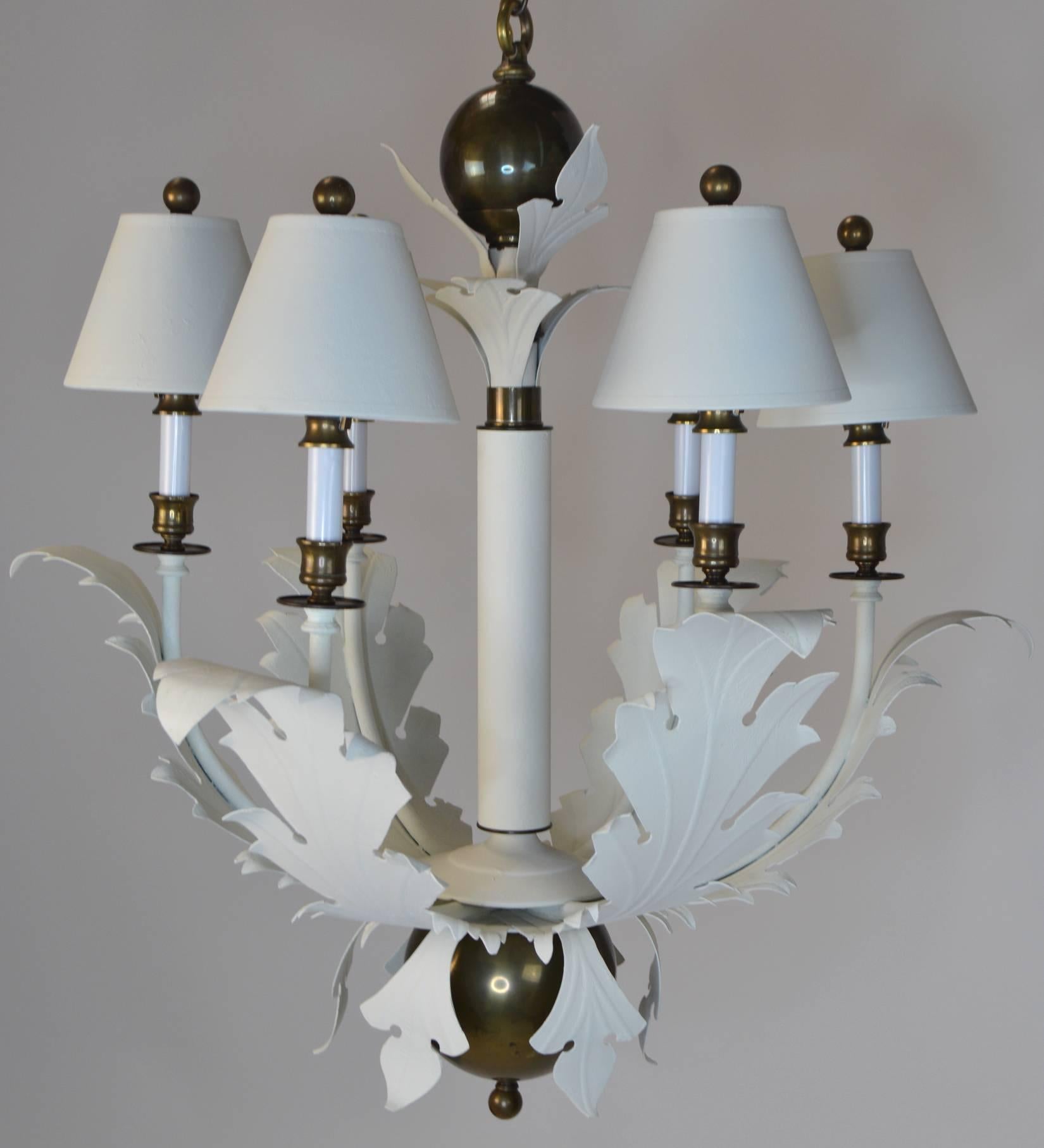 A 1980s, Glam chandelier by Hart Lighting, in the form of a central shaft and six scrolling leaf arms holding brass accented candle sockets. With original shades and brass mounts and finials.