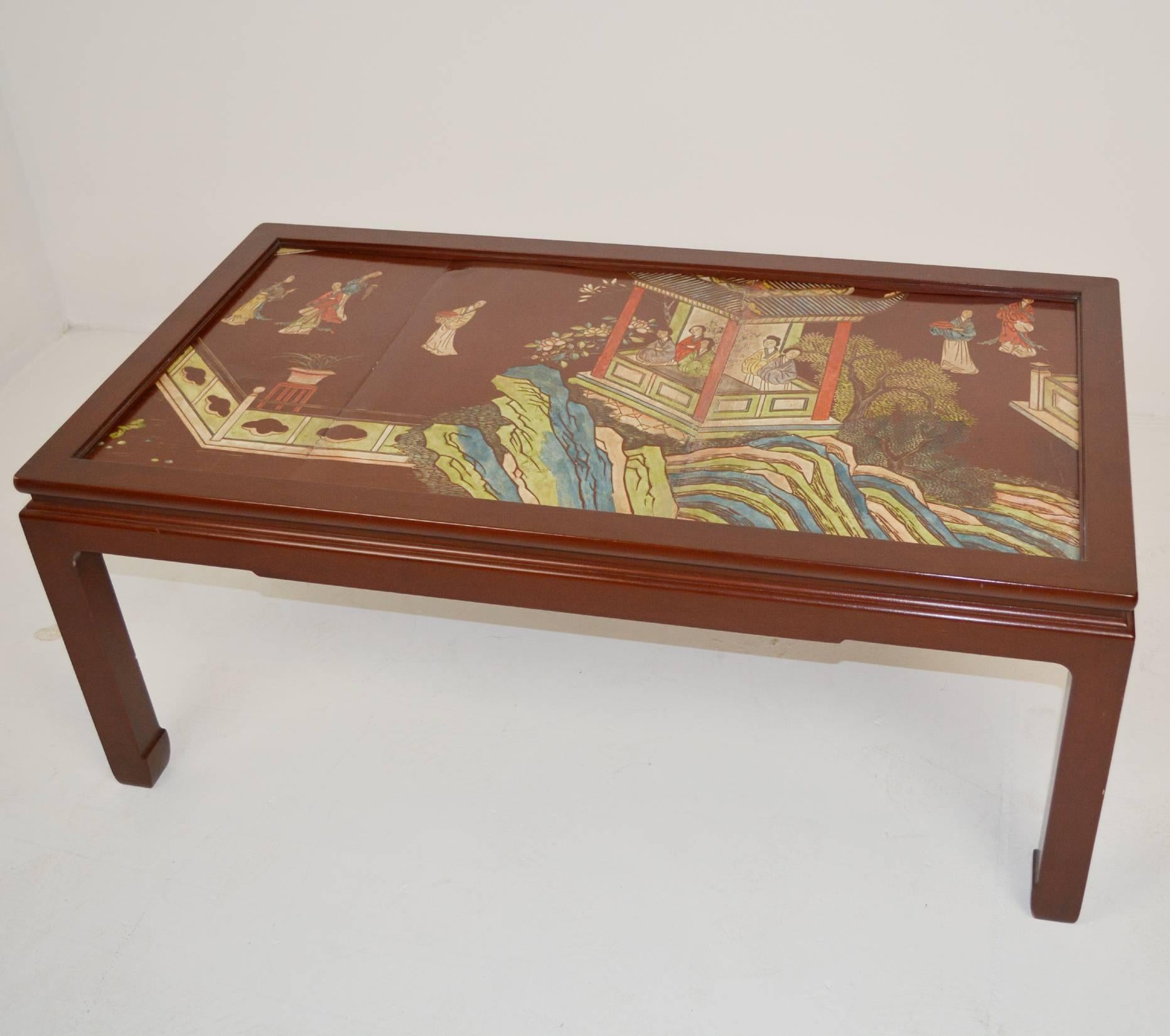 A Chinese coromandel lacquer panel mounted in a lovely Chinese red frame as a coffee table.