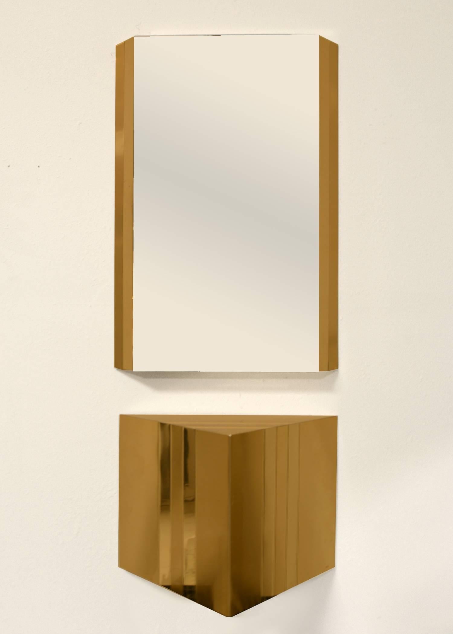 Two tone brass wall hung consoles with matching mirrors. Sold as a set of one console and one mirror. Two sets available. 
Mirror  36” H  x  24” W  x  3” D
Console 17” H  x 23.5 ” W  x  12” D