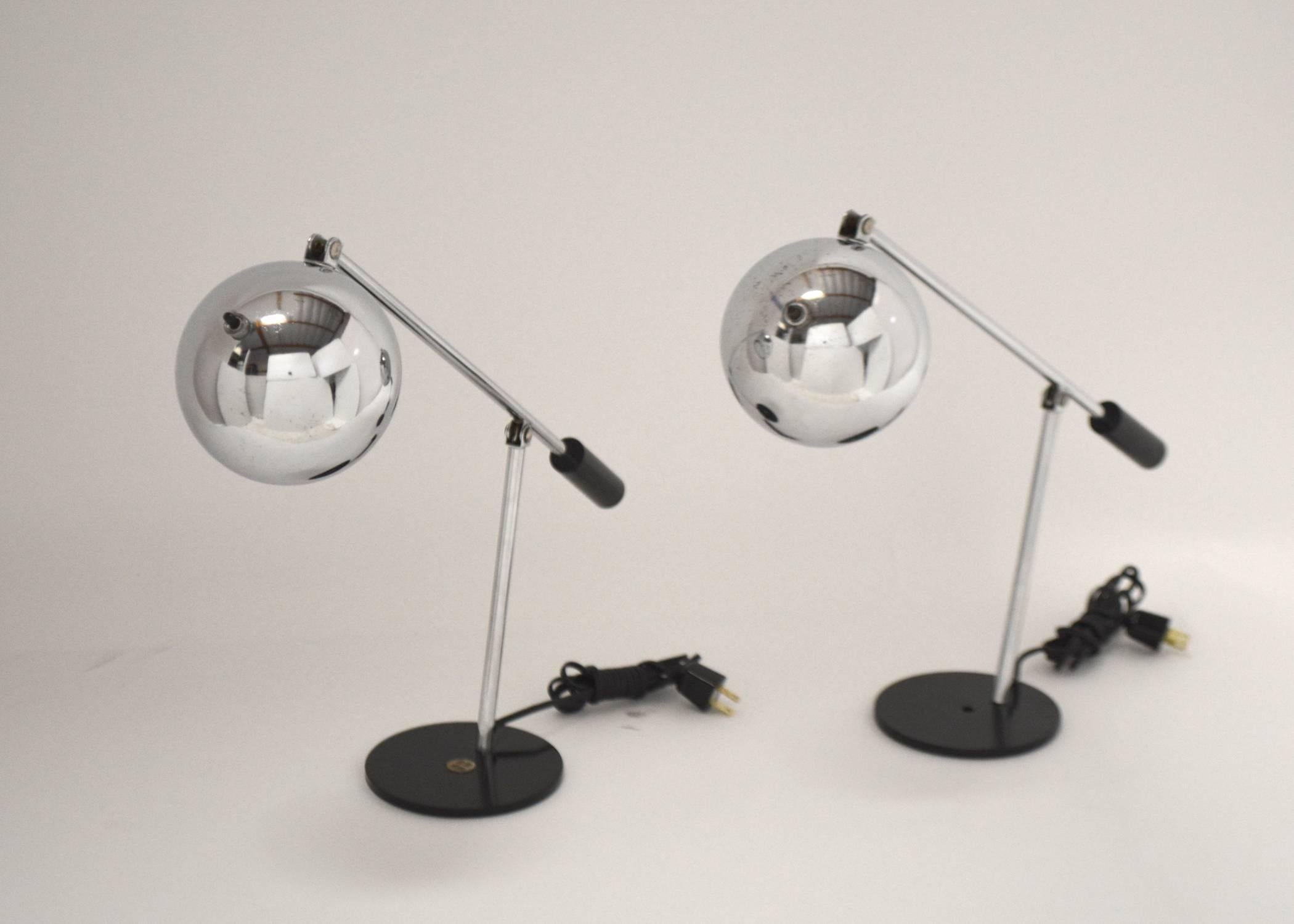 Pair of rare articulating lamps manufactured by Tensor. Chrome with black painted base.
