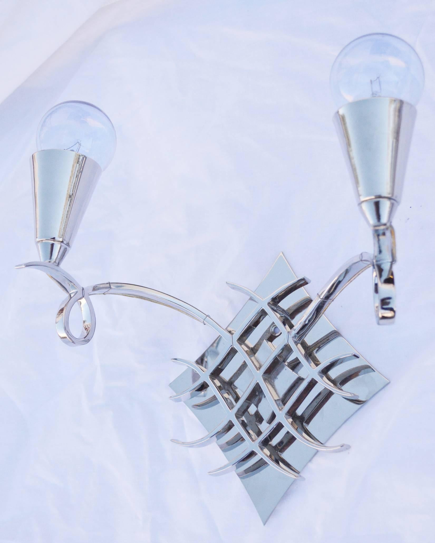 A lovely pair of French scroll sconces in the style of Jules Leleu. Newly nickel plated and rewired, with a custom backplate for US installation.