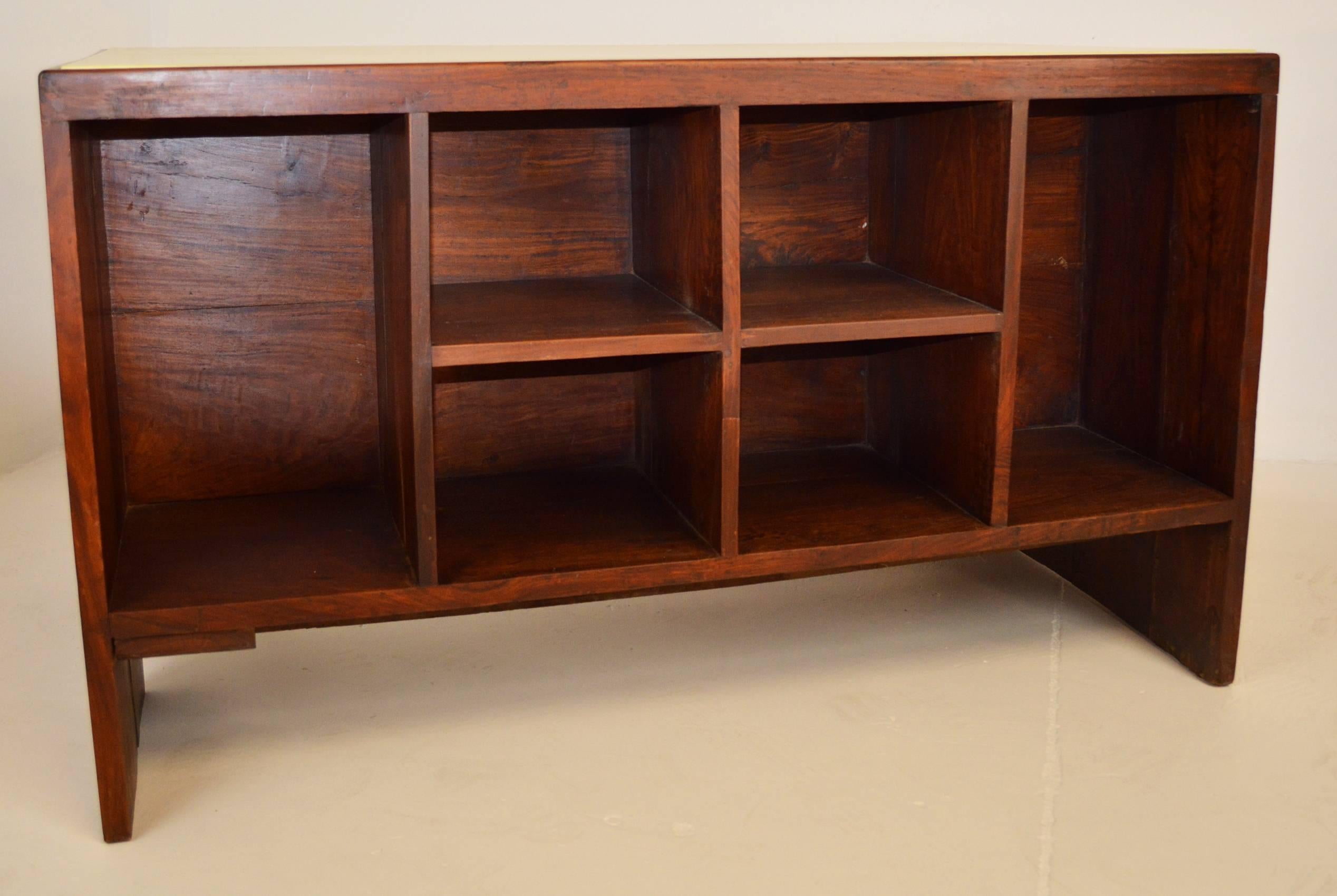 Indian rosewood desk by Pierre Jeanneret from Chandigarh, circa 1957-1958. Kneehole desk with an open cubby and drawer, and a bookcase on the opposite side.
 Leather top has been replaced at some point. From the Secretariat building (1958). Model