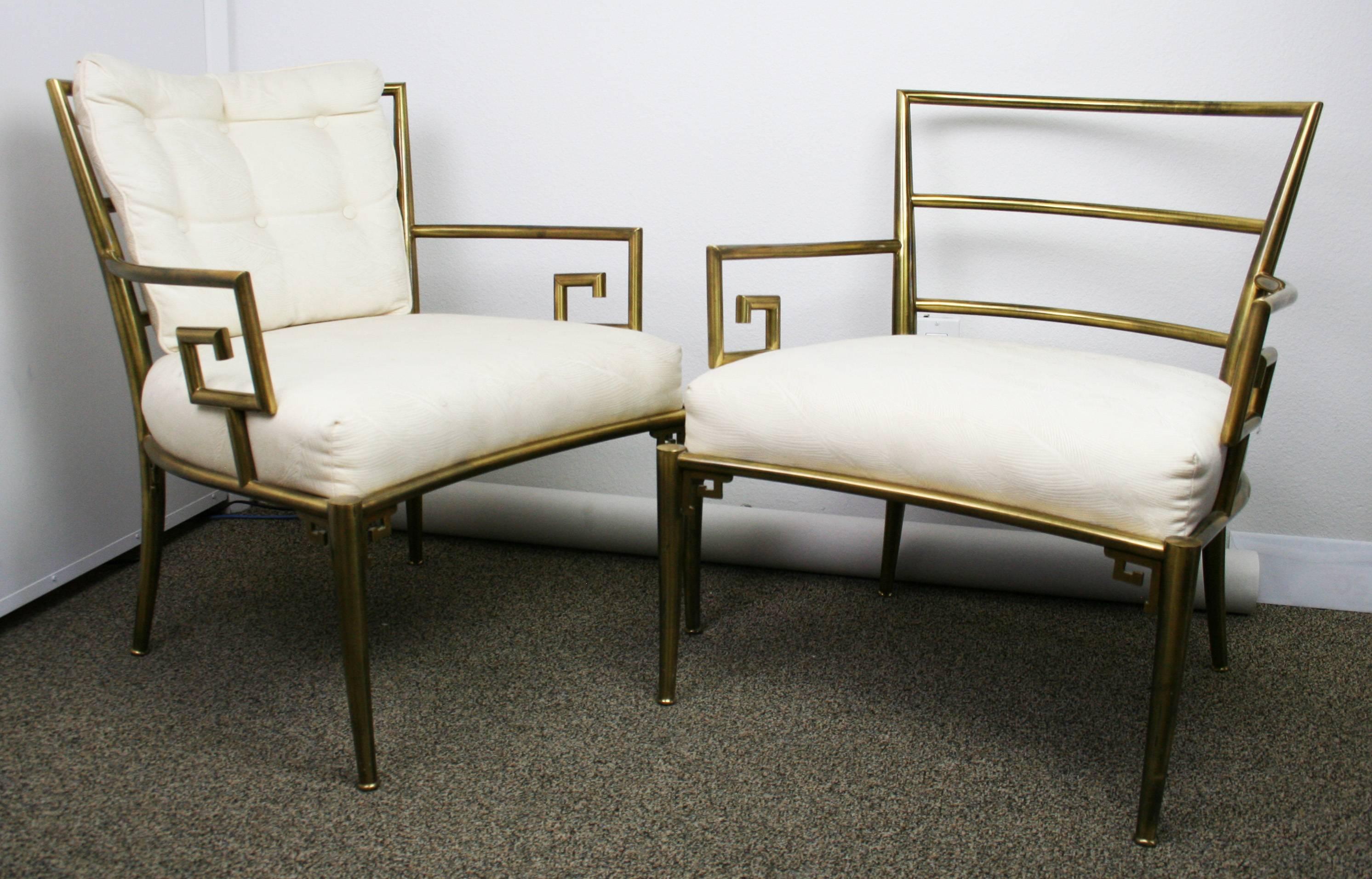 A rare pair of brass lounge chiars with greey key detail at armrest. 16.5 Seat Height