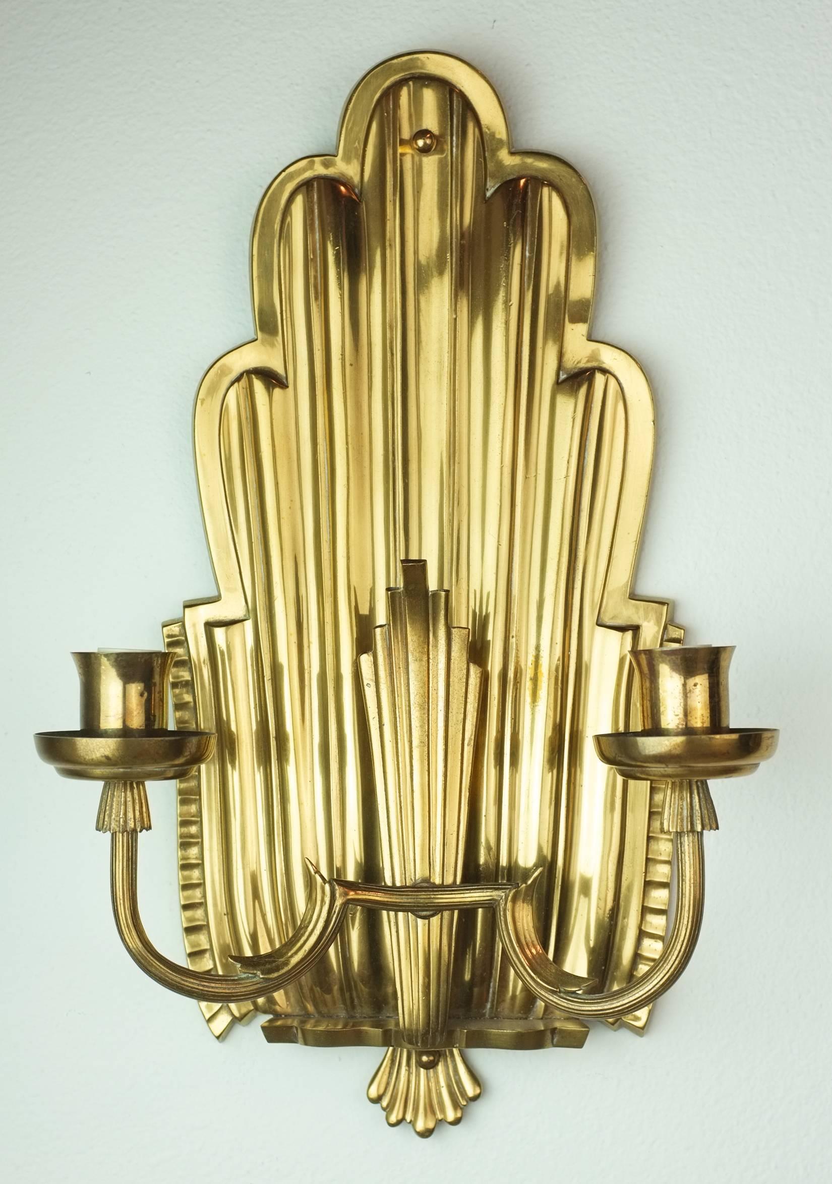 A pair of very nice Swedish Grace Art Deco period sconces. Two reeded arms come off a scalloped and reeded shield back. Fantastic quality. Rewired for US.