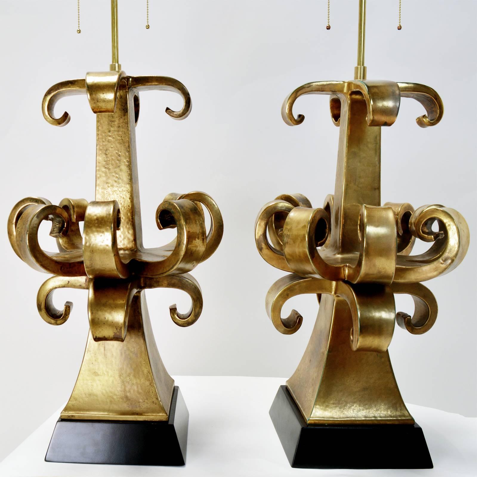 A monumental pair of sculptural lamps by Zanuso for Marbro Lamp Co. Gold glazed terracotta form on a black painted wood base. Rewired with new double socket cluster. Appears to have earlier repairs.