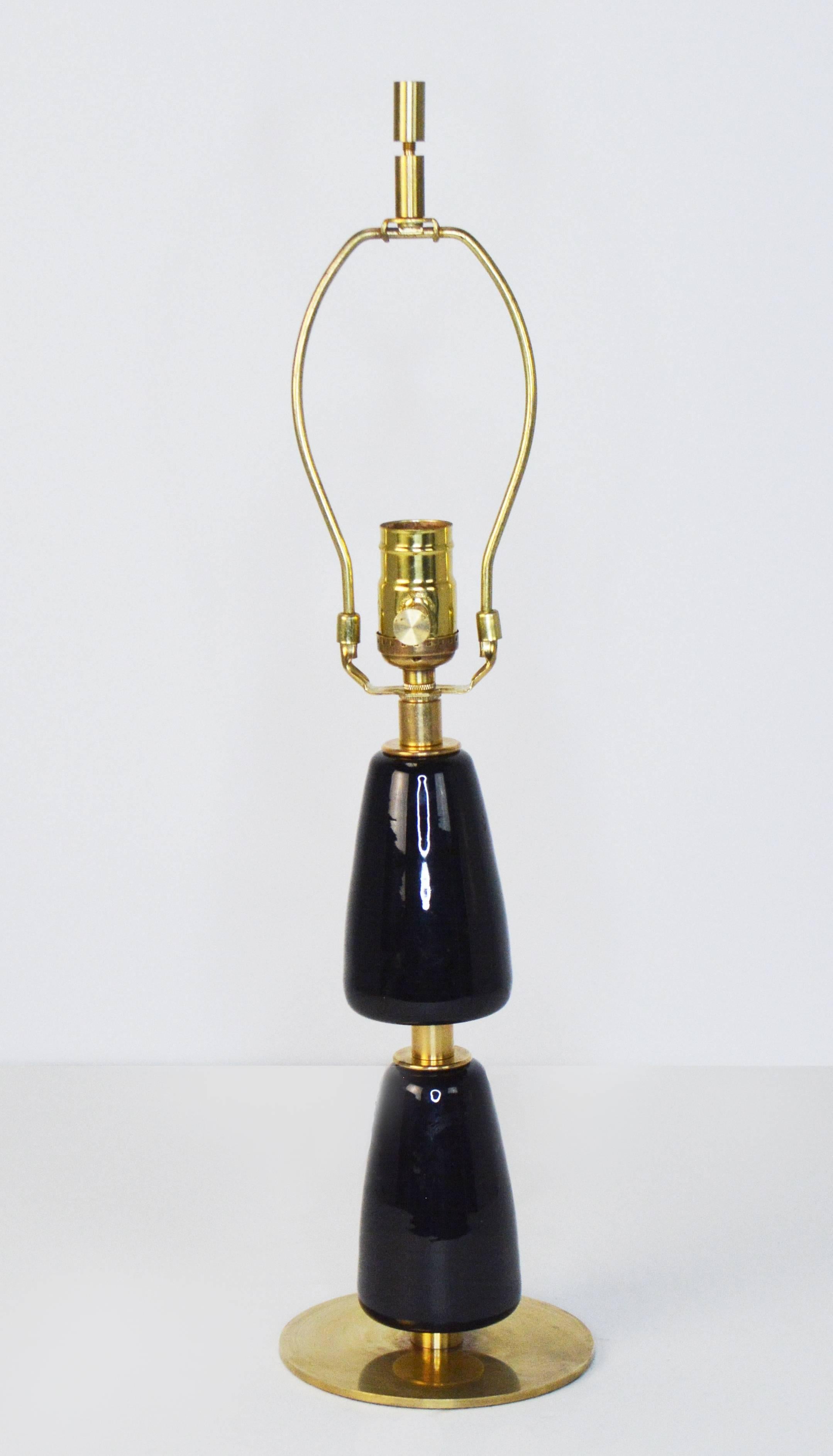 A lovely small-scale lamp in the style of Jacques Adnet, comprising two dark amethyst glass tear shaped drops on a brass base and mounts. Rewired for US use, with new socket and French braid silk cord. Measures is 19 1/2