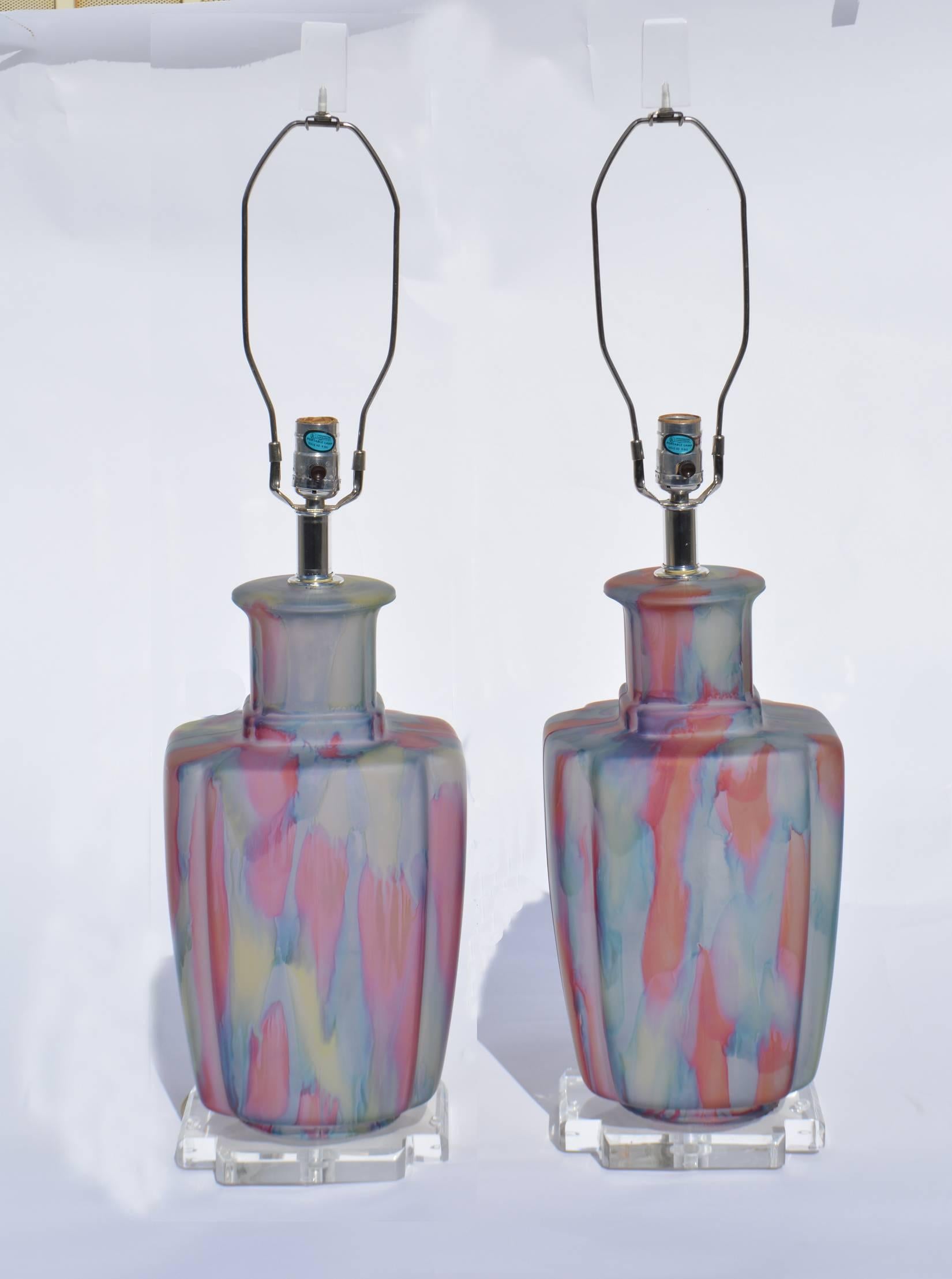 Unique pair of frosted glass Bauer lamps in tones of blue and pale pink with Lucite bases and finials. Internally lit and newly rewired with three-way sockets, American, circa 1980s.