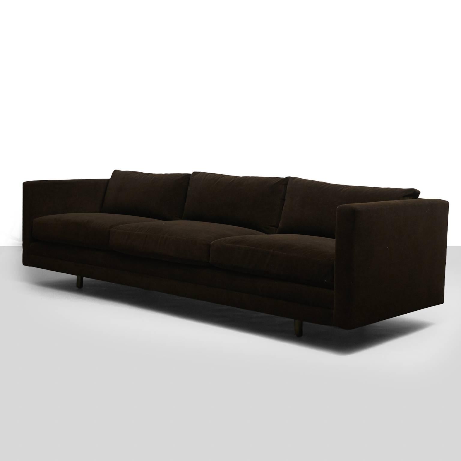 A long “Tuxedo” sofa from the Harvey Probber for modern collection. Recently restored in a brown velvet with down filled cushions. Retains the original label.