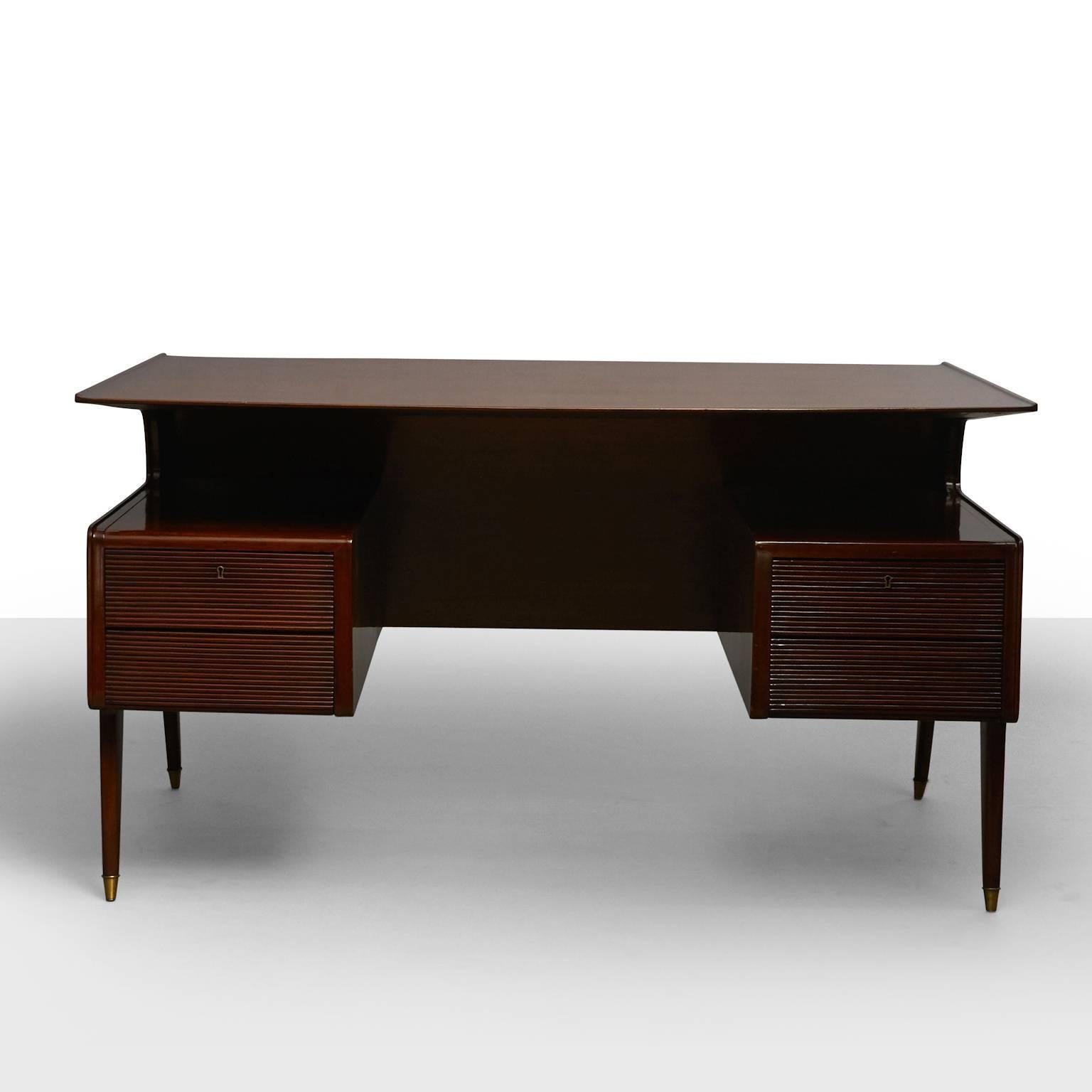Guglielmo Ulrich style executive desk, possibly made by Dassi
An elegant Executive desk of lacquered palisander and brass. Features
four drawers, cantilevered top and brass details on tapered legs,
Italy, circa 1950s.
  