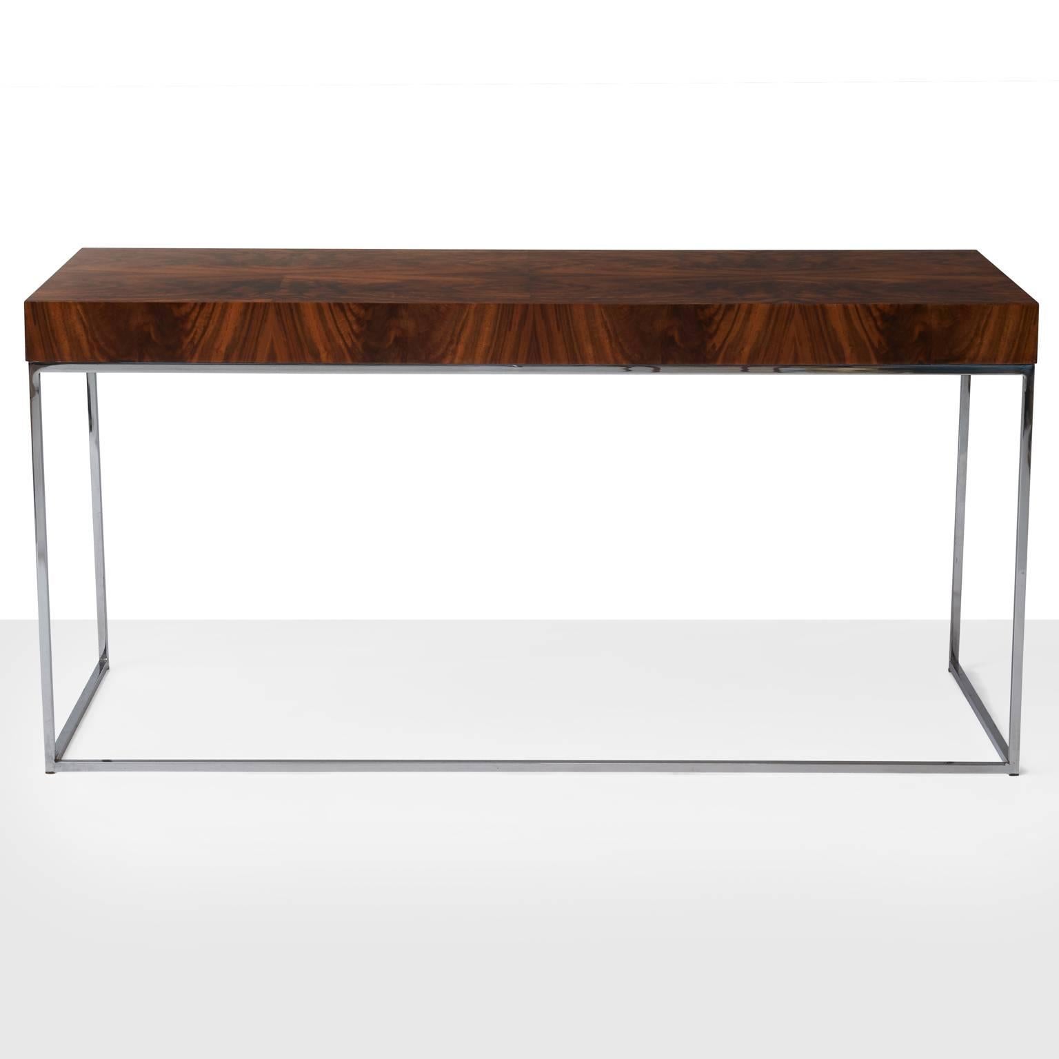 A desk or writing table by Milo Baughman. Bookmatched rosewood surface set atop a slender frame of chromed steel.
 