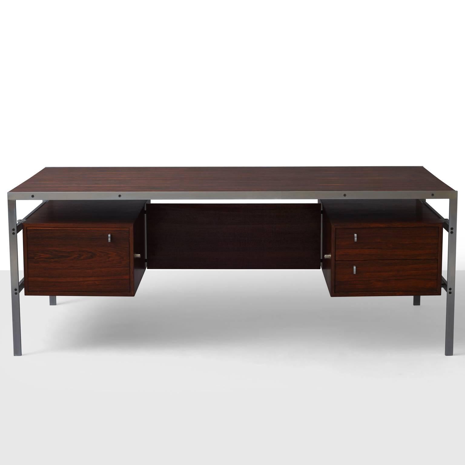 An executive desk made of Wenge-veneered wood and chrome-plated steel. Three drawers, key included.