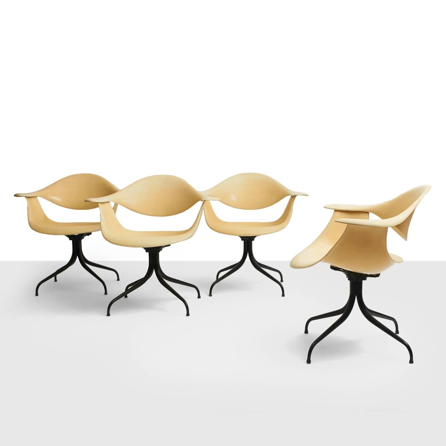 A rare set of four swag legged dining chairs designed in 1958 by George Nelson for Herman Miller. Cream colored fiberglass on a black enameled base. All in excellent original condition. First editions from 1958.
Price shown is for a set of 4 chairs.