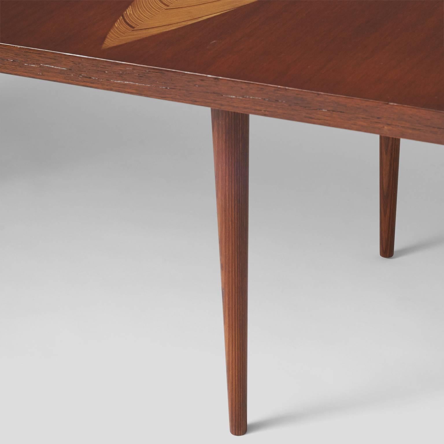 A rare coffee table designed by Tapio Wirkkala for Asko with three leaf pattern inlays of laminated padouk, birch, hazelwood and maple.
Denmark, circa 1950s.
 
