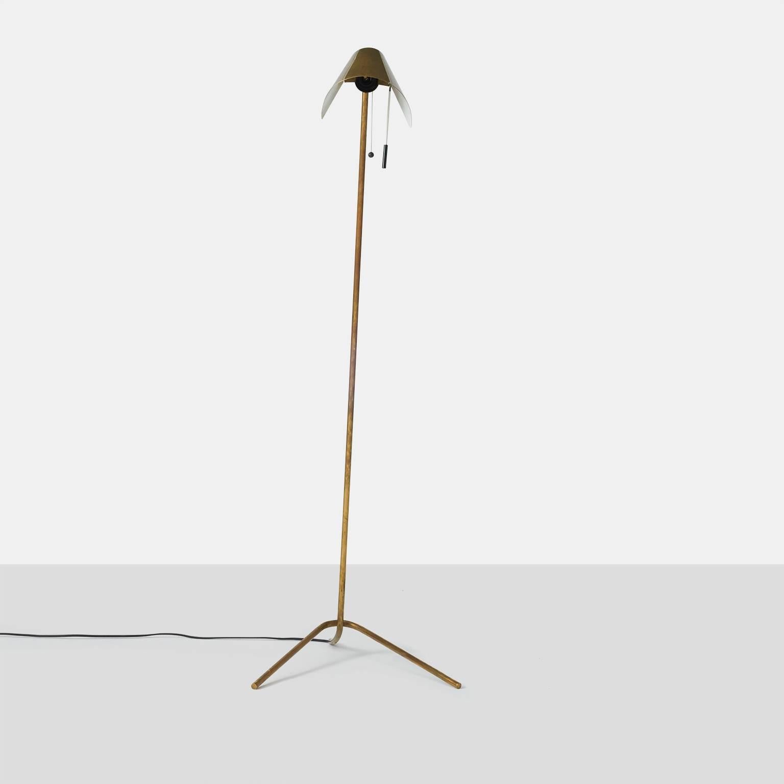 A brass floor lamp by Bergbom with a three-leg base. Signed with the manufacturer's mark to underside of base: “Bergbom”. Retains original wiring.
  