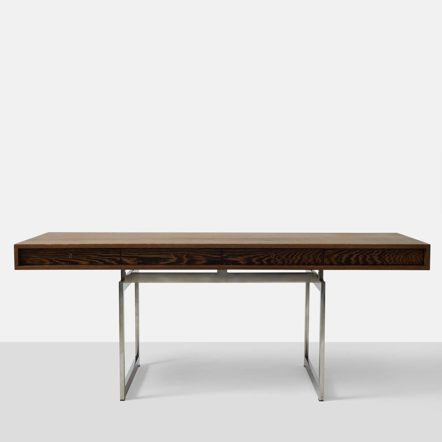 A rare and early Bodil Kjaer desk in wenge by E. Pederson & Sons. The desk has four drawers with a chrome and brass key. Polished chrome-plated steel frame. Signed with applied manufacturer's label.
