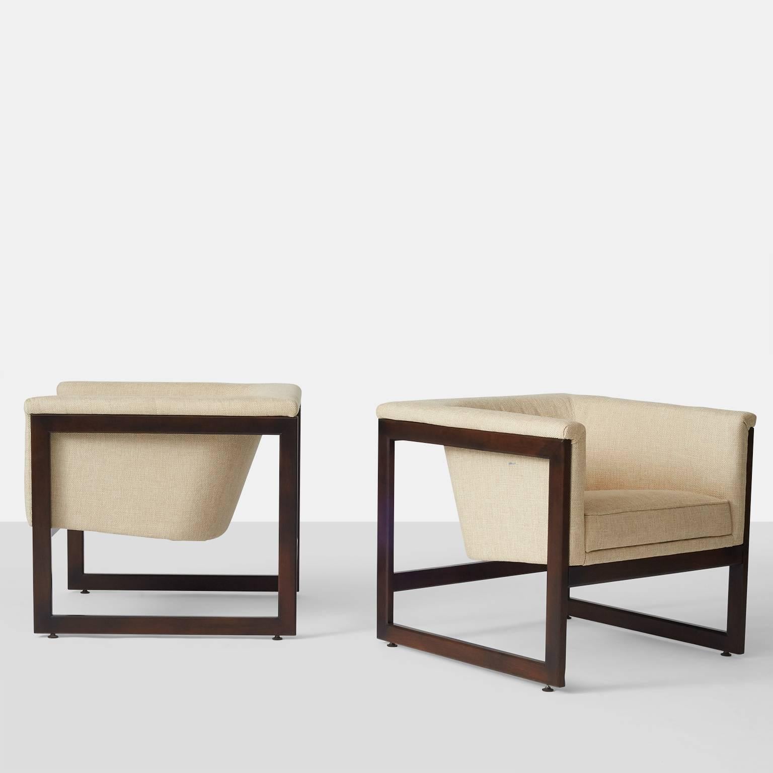 A pair of Milo Baughman floating cube lounge chairs with wooden frame and upholstered seat in a ivory woven fabric.  Recently restored.