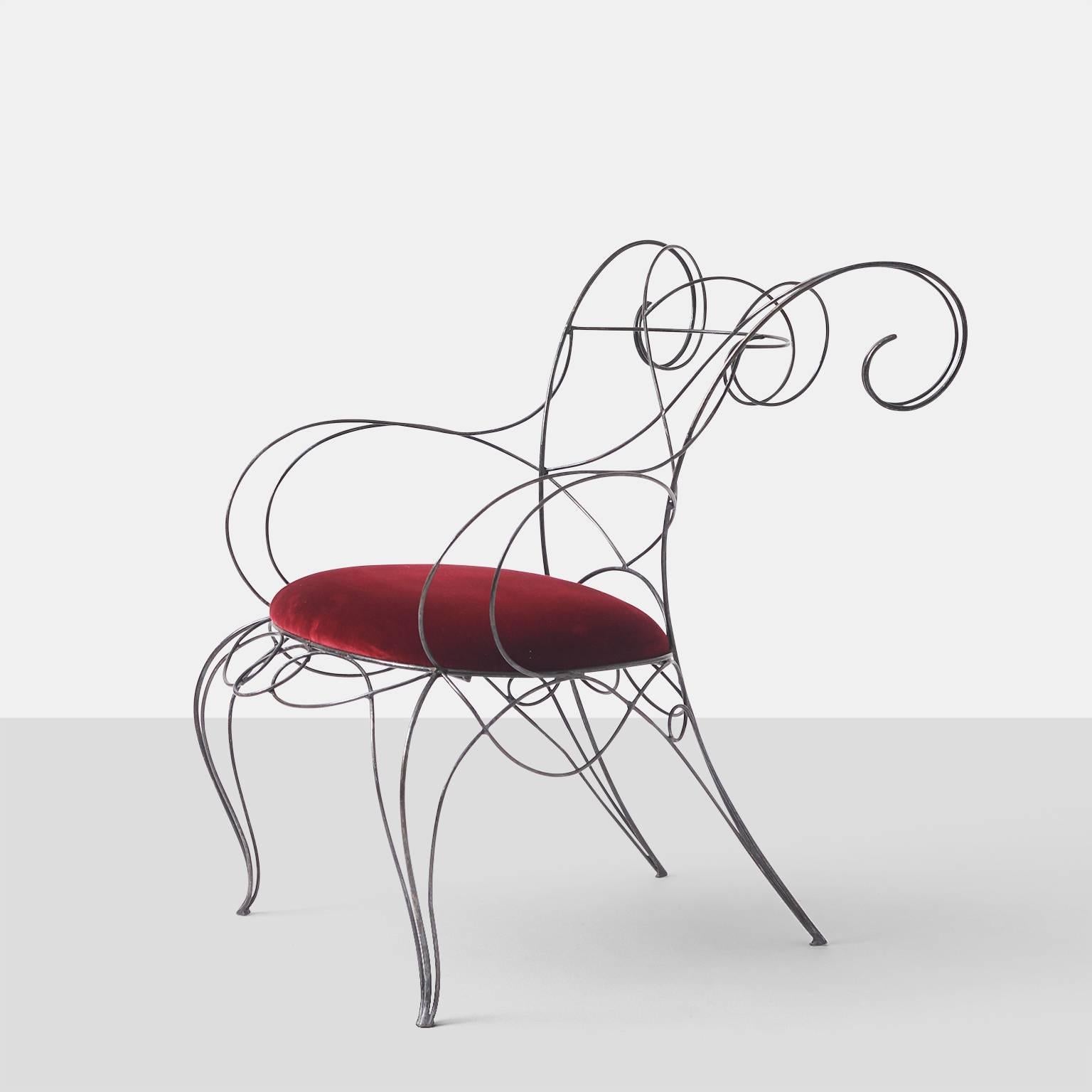 A hand made bent steel rod arm and side chair with a deep red silk velvet seat.
Side chair dimensions are 33.5