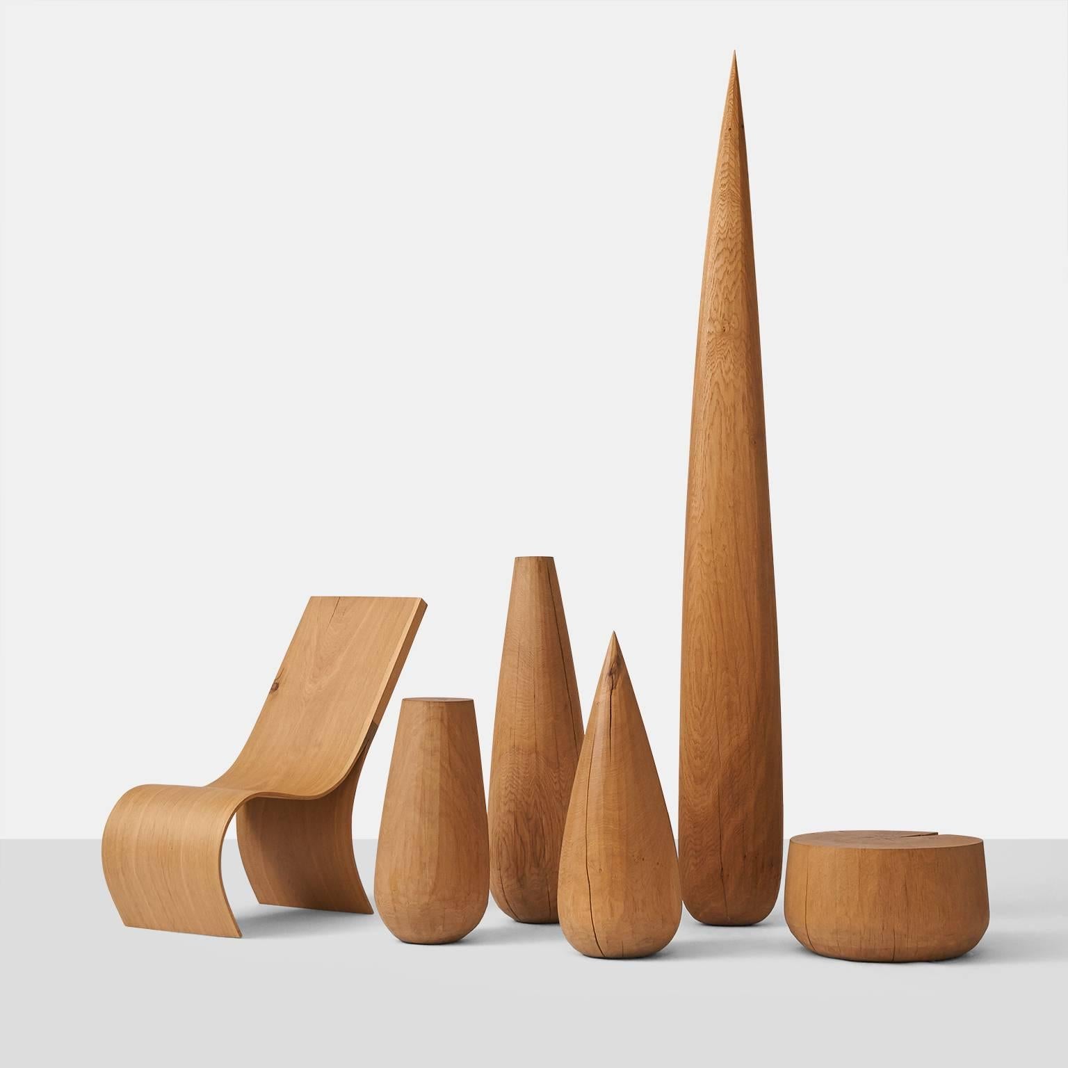 A collection of five monoliths created by German artist Kaspar Hamacher from solid pieces of oak tree trunks. Oak is from naturally fallen trees. Tallest item is 93
